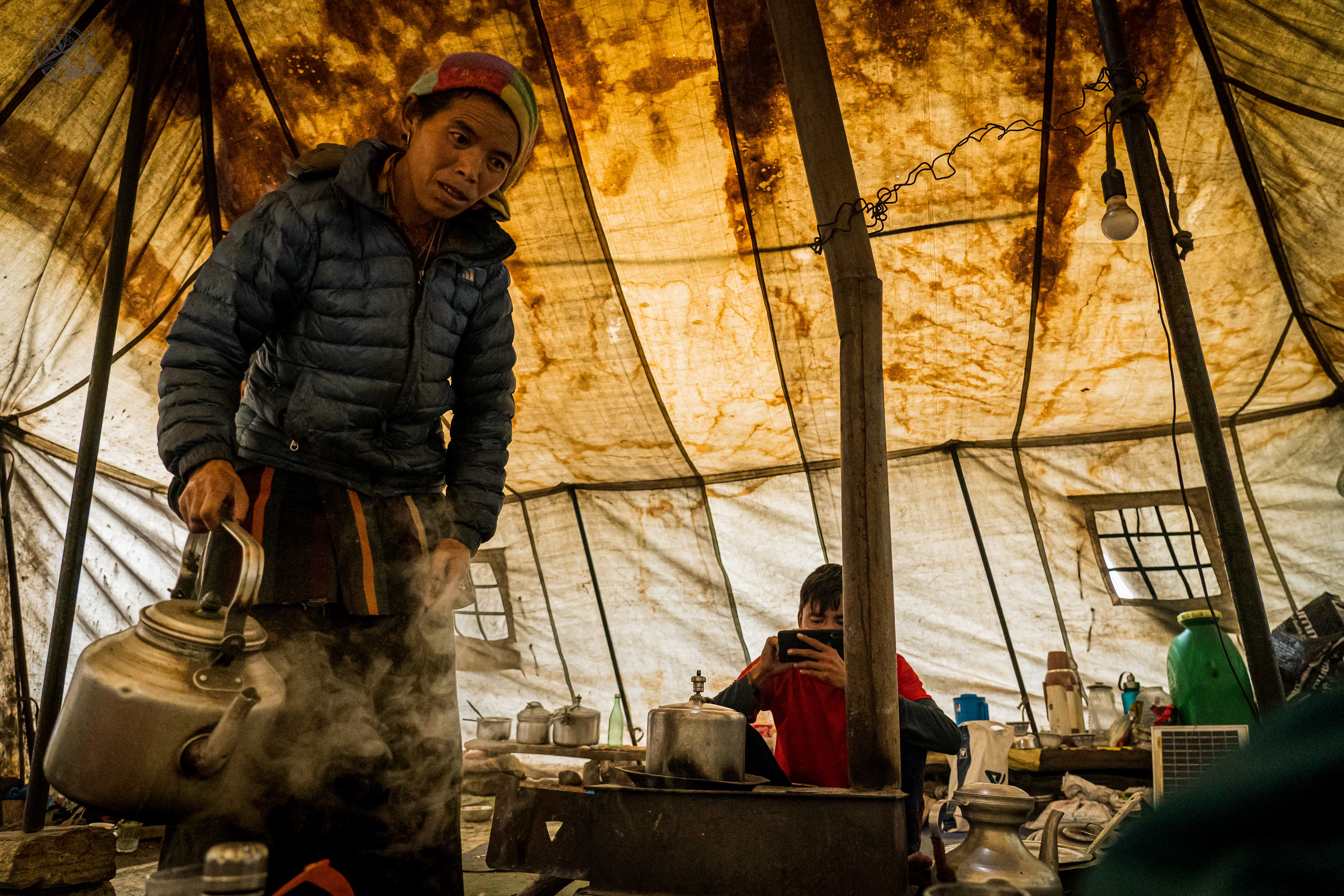 Women serving hot water in her temporary setup hotel 'Rahman"