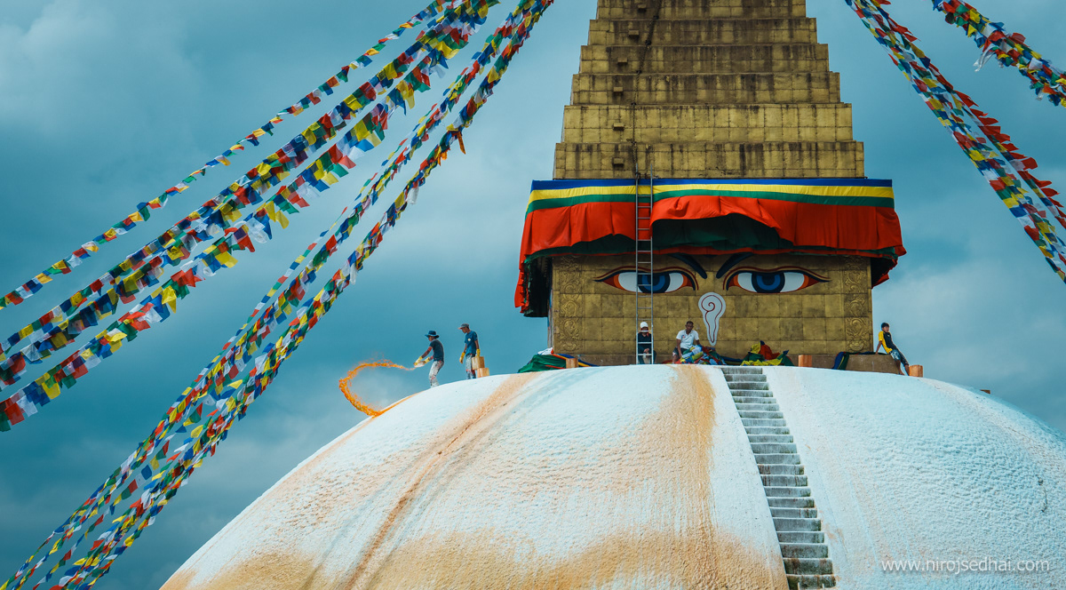 People splashing paint around the Bouddhanath Stupa
