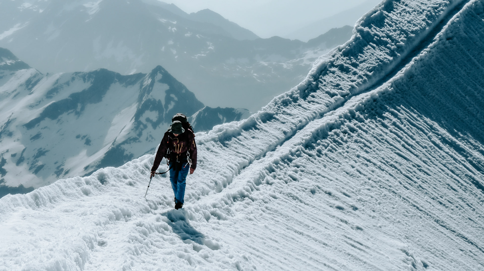 Mountaineer on the snowy ridge