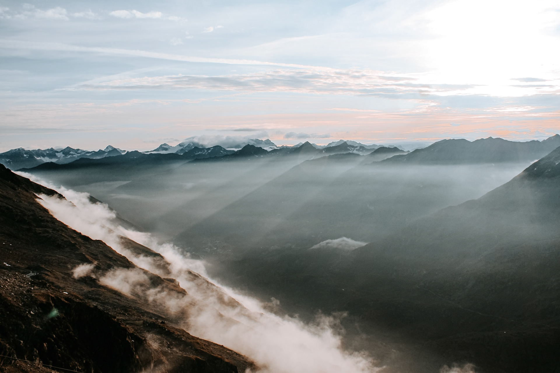 Rays of sunshine illuminate the morning fog seen from the Ramolhaus