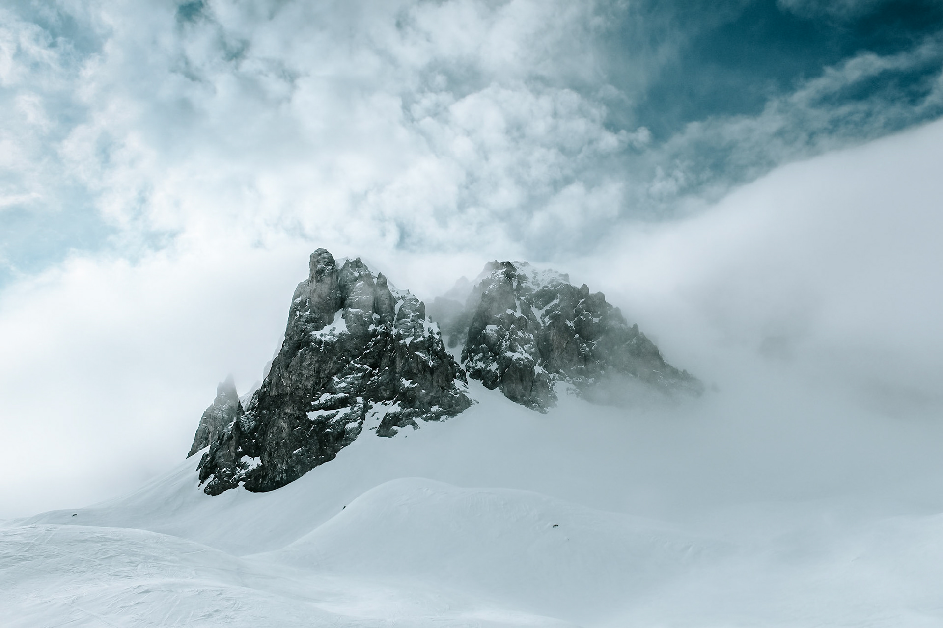 Mountain peaks surrounded by wafts of mist