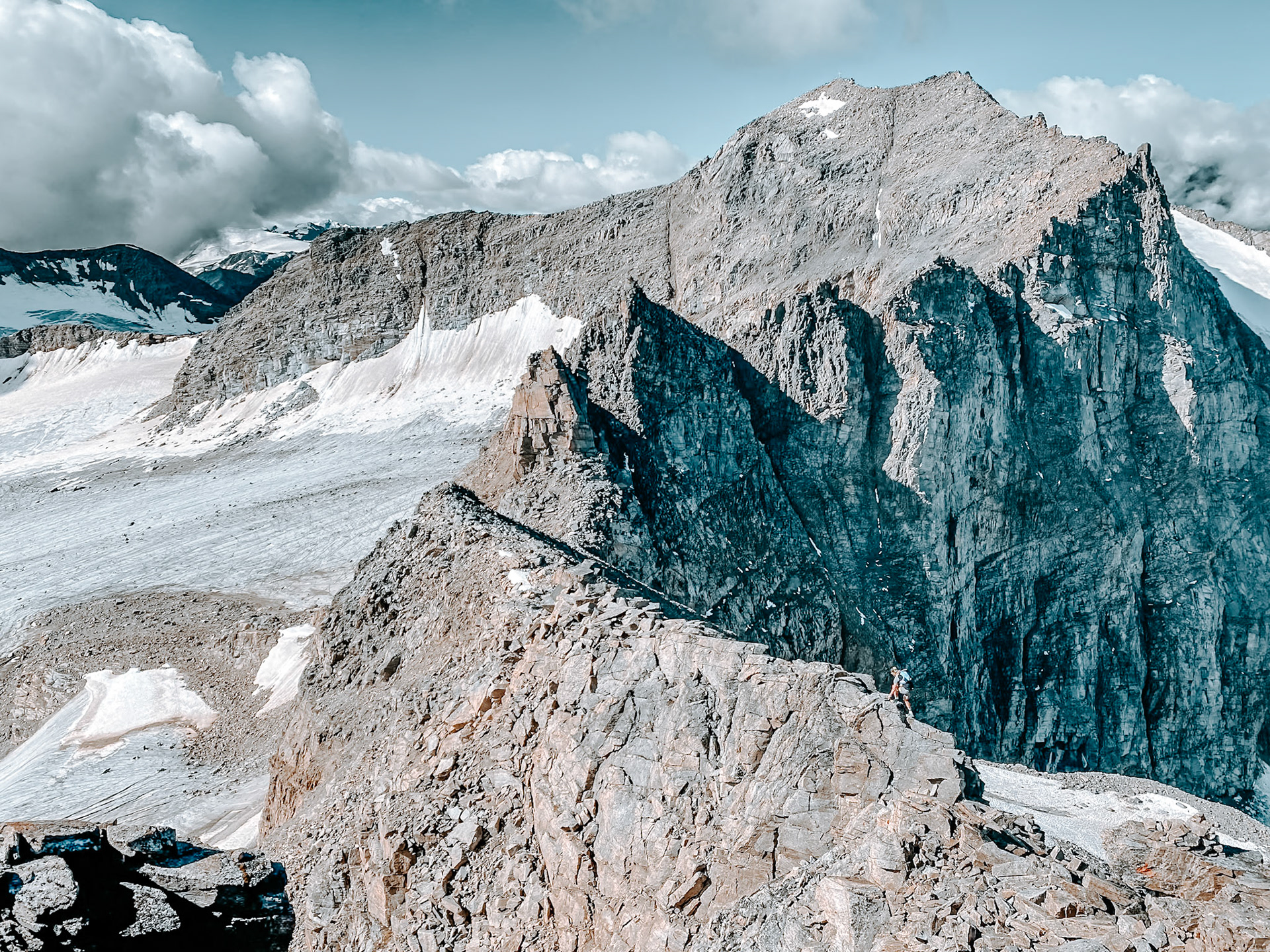 Trailrunner on a long ridge in the Ortler Alps seen from Hoher Angelus