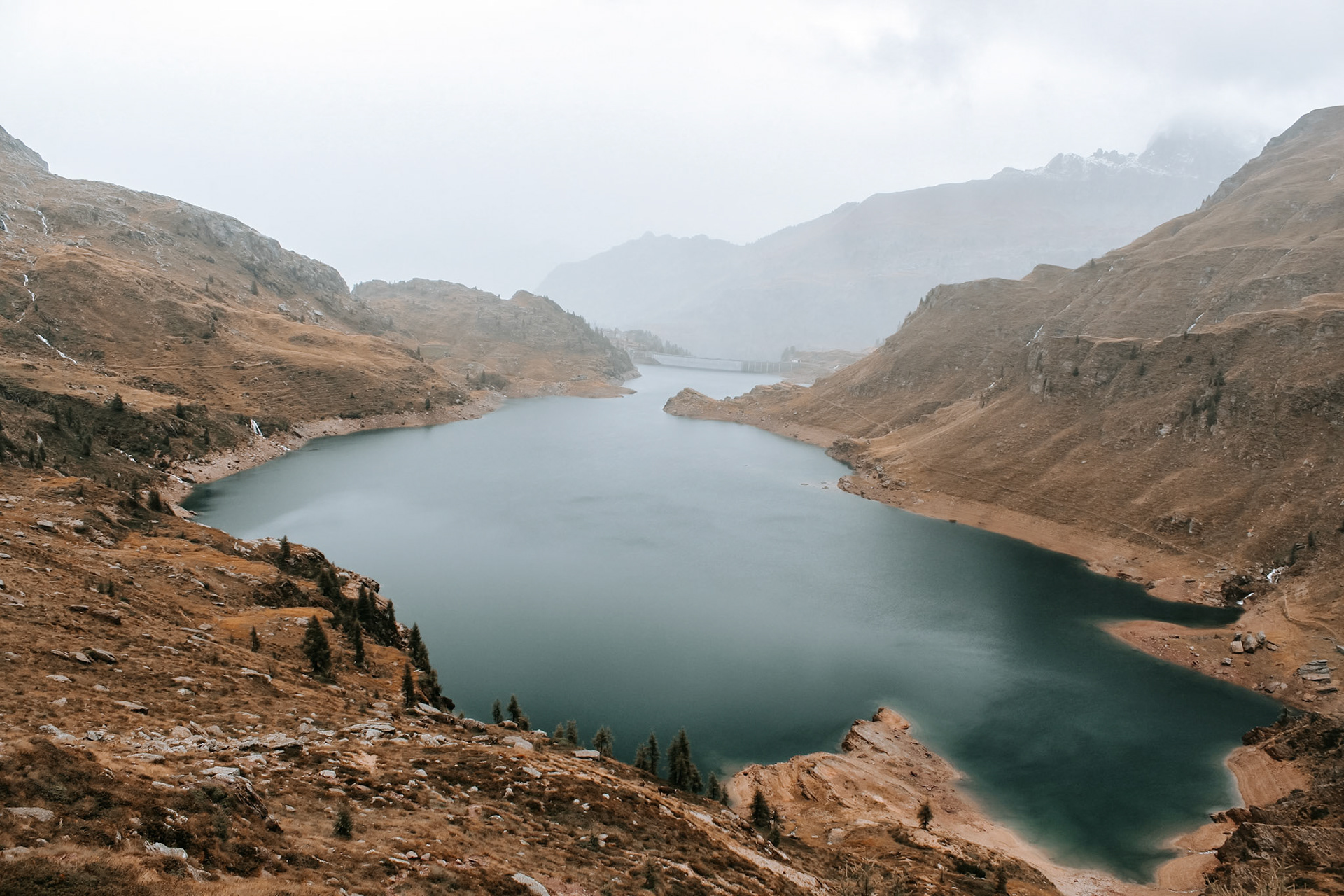 A dam in the fog in the Bergamasker Alps