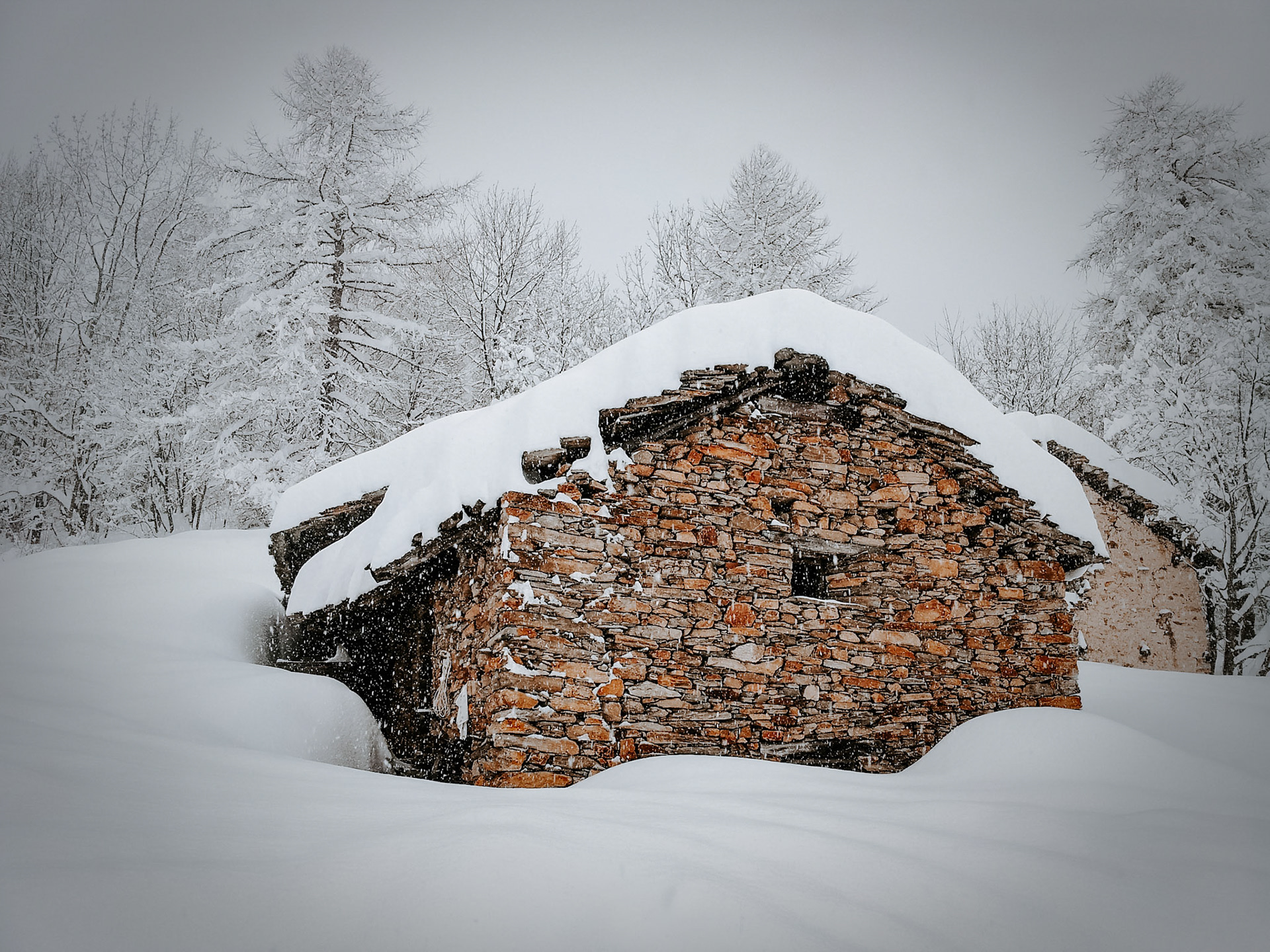 Old house covered by snow in Valle Maira