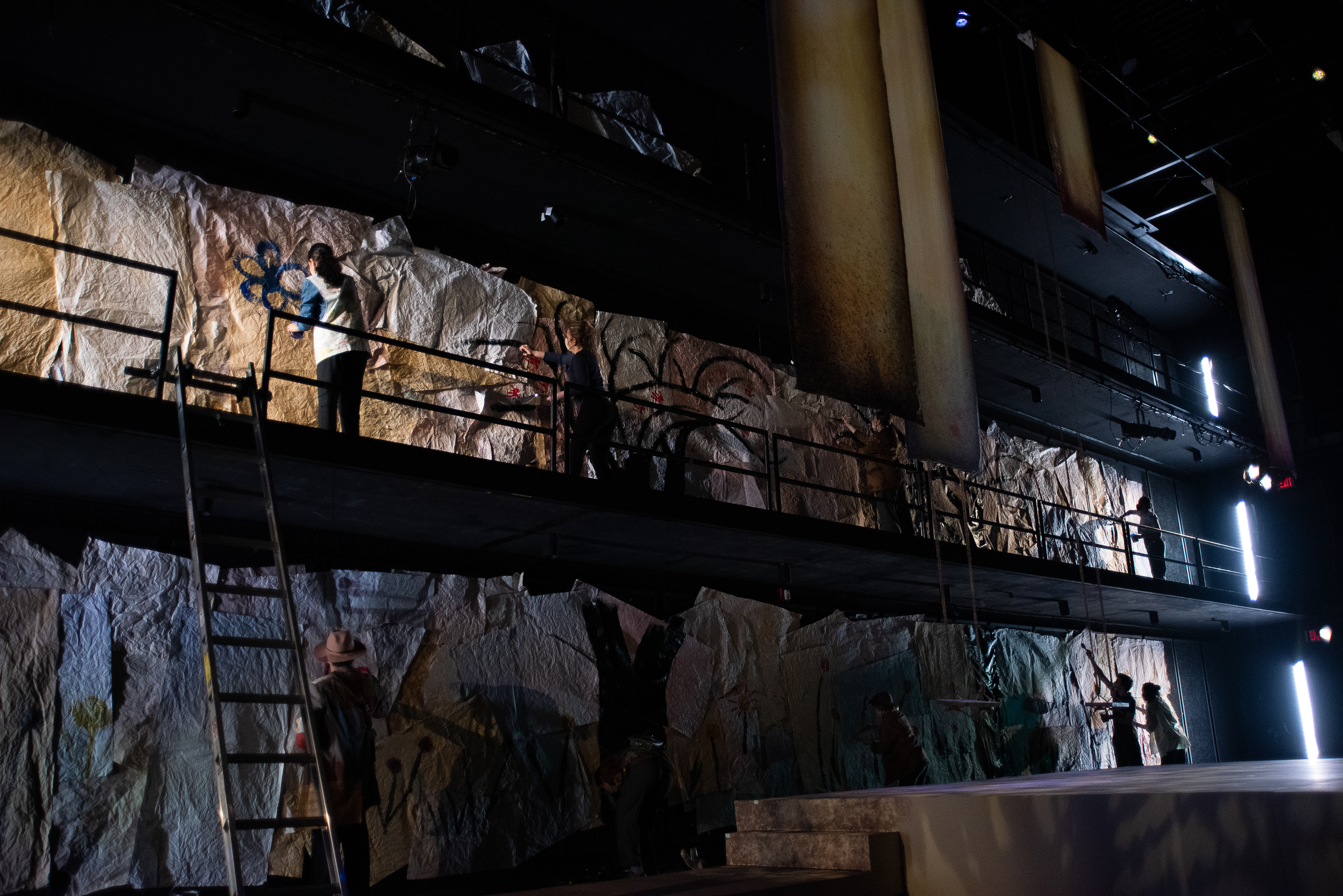 Actors painting back wall
