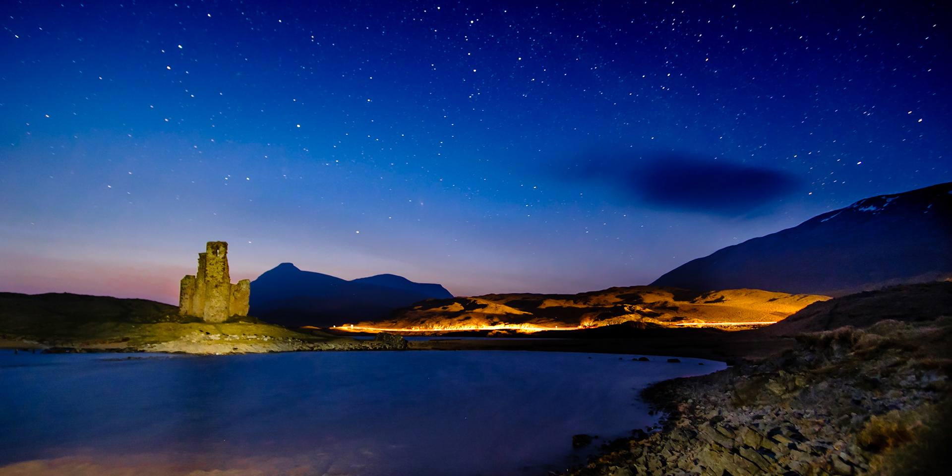 Ardvreck Castle in Assynt, with the last of the day's glow in the sky.