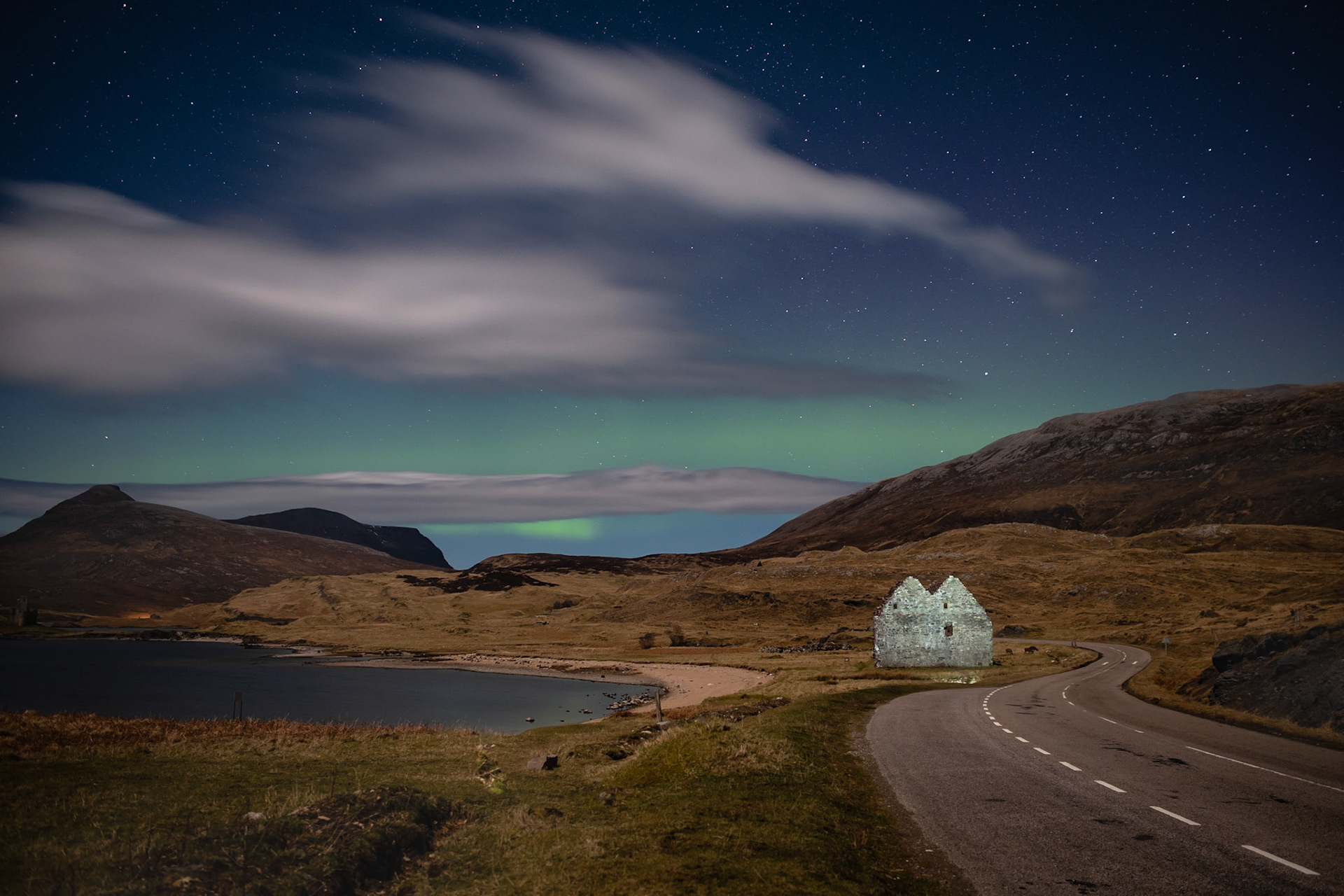 The ruins of Calda House, on Loch Assynt, with a touch of aurora above.