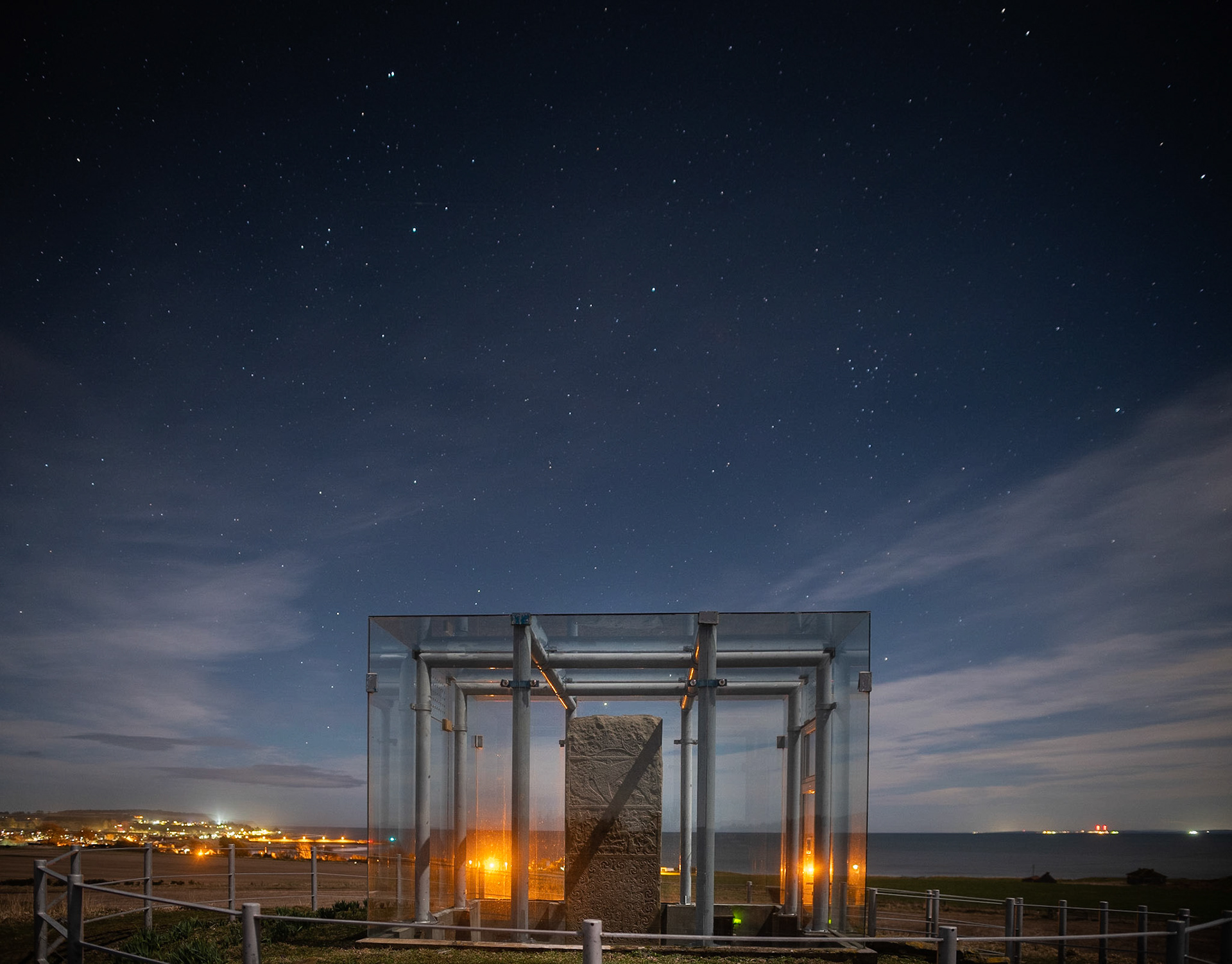 The Shandwick Stone; an 8th century Pictish stone, encased in glass for protection, stands sentinel above the seaboard village of Shandwick.