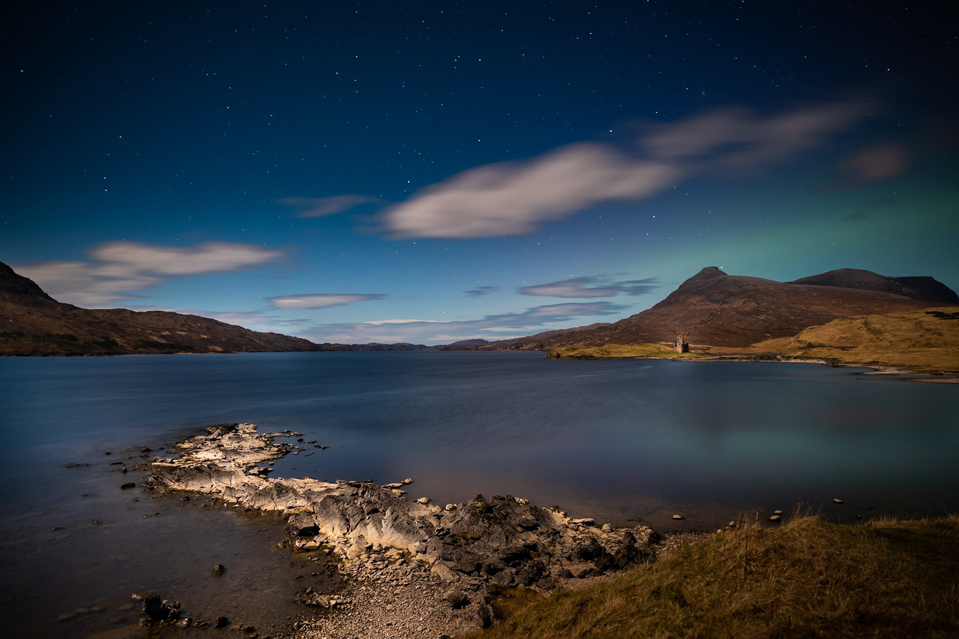 Looking across the moonlit Loch Assynt towards the ruins of Ardvreck Castle.