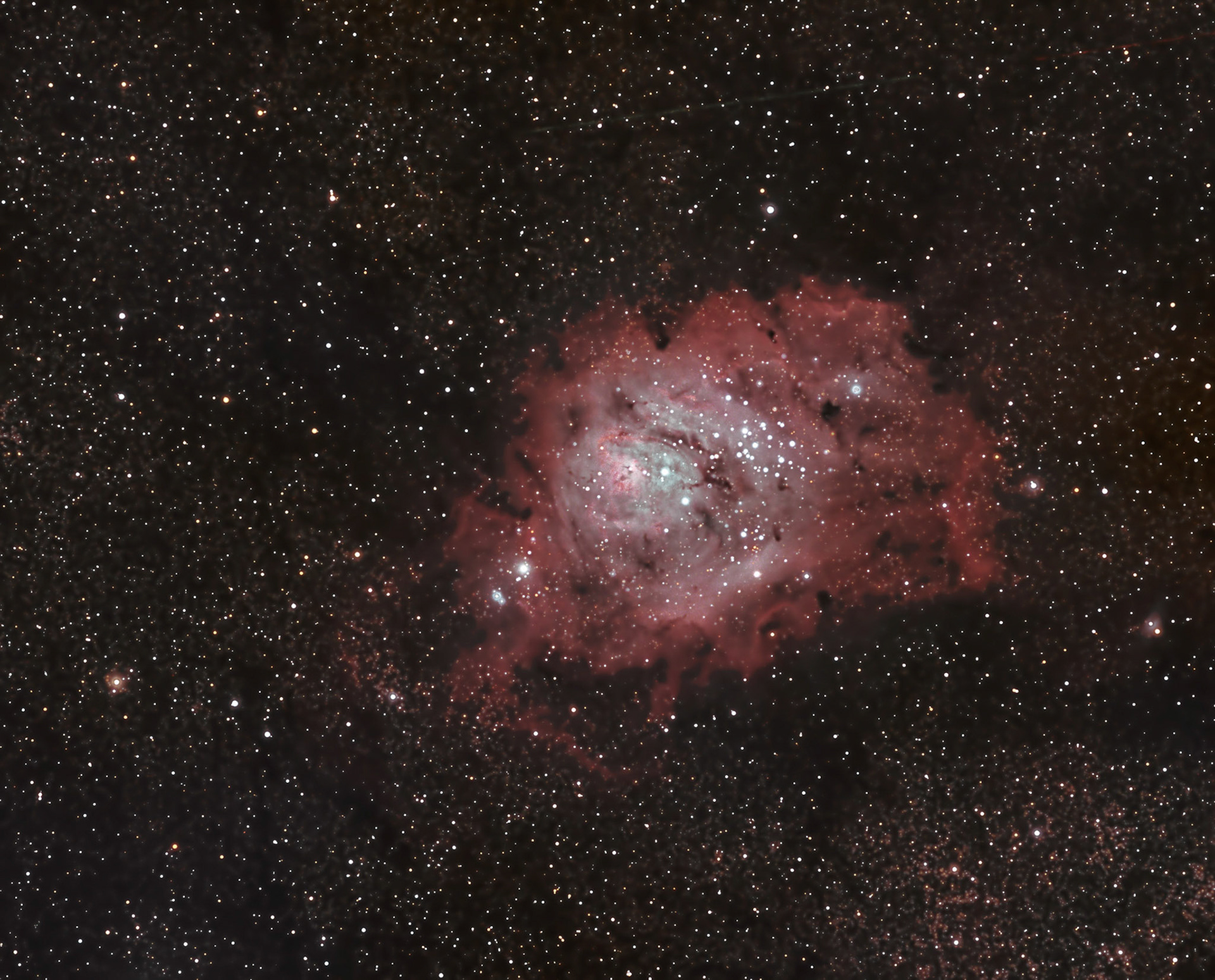 M8, the Lagoon Nebula. Mostly hydrogen gas, which is associated with star formation. Just over 4,000 light years from earth.