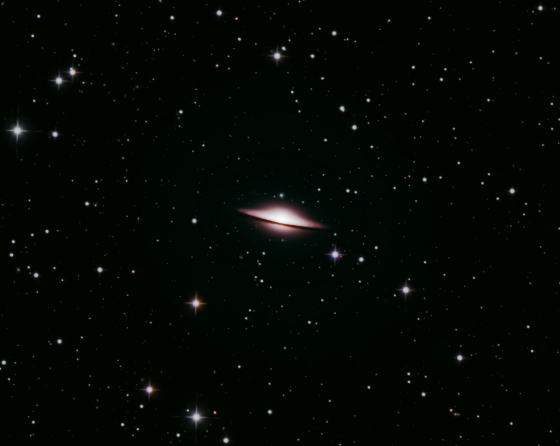 M104 Sombrero Galaxy - a peculiar galaxy of unclear classification in the constellation borders of Virgo and Corvus, being about 31.1 million light-years from the Milky Way galaxy. It has a diameter of approximately 49,000 light-years, three-tenths the size of the Milky Way.  It has a bright nucleus, an unusually large central bulge, and a prominent dust lane in its outer disk, which is viewed almost edge-on. The dark dust lane and the bulge give it the appearance of a sombrero hat (thus the name). This was a combination of images taken with Red, Green, Blue, and Luminance filters. 