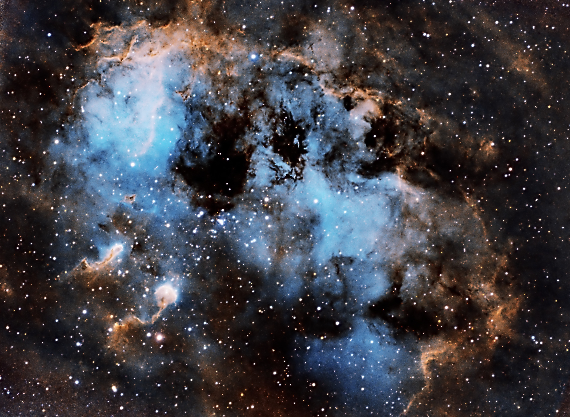 IC410 is a dusty emission nebula located in the constellation of Auriga at about 12.000 ly from Earth. The gas structures in this picture are lit by the radiation from the open star cluster NGC1893 that lies in the center of the nebula. This star cluster is about 4 million years old, but in astronomical terms it is still very young, with hot, massive stars. At the bottom-right of the star cluster two more dense structures are visible. These are similar to the famous Pillar of Creation and they are composed of dust and gas leftover from the formation of the star cluster and are very likely to give birth to more stars in the future. The tadpoles are formed from the stellar winds and radiation pressure from the stars in NGC 1893.