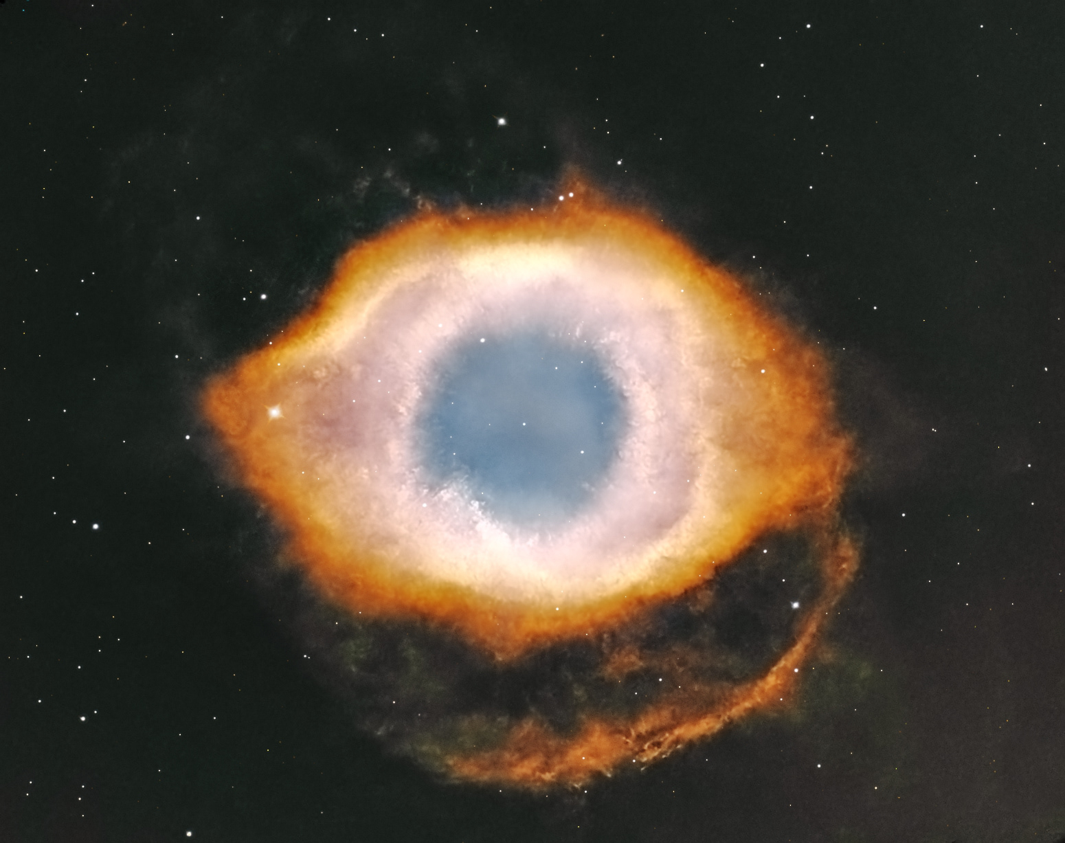The Helix Nebula (NGC 7293) in NB is a planetary nebula located 650 light years from Earth in the constellation Aquarius. It is one of the closest planetary nebulae to Earth, as well as one of the brightest. Its striking appearance has earned it the nickname the Eye of God Nebula.  Planetary nebulae like the Helix are formed when stars that are not massive enough to go out as supernovae expel their outer envelopes at the end of their evolutionary cycles. The stars become white dwarfs – hot remnant stellar cores – that energize the ejected material. White dwarfs are very dense, typically packing a mass similar to that of the Sun into a volume comparable to that of the Earth. The intense ultraviolet radiation from these stars causes the ejected layers of gas to glow.  The Helix Nebula is believed to have formed about 10,600 years ago, when the central star, catalogued as GJ 9785, reached the end of its life cycle and shed its outer layers into space. HOO