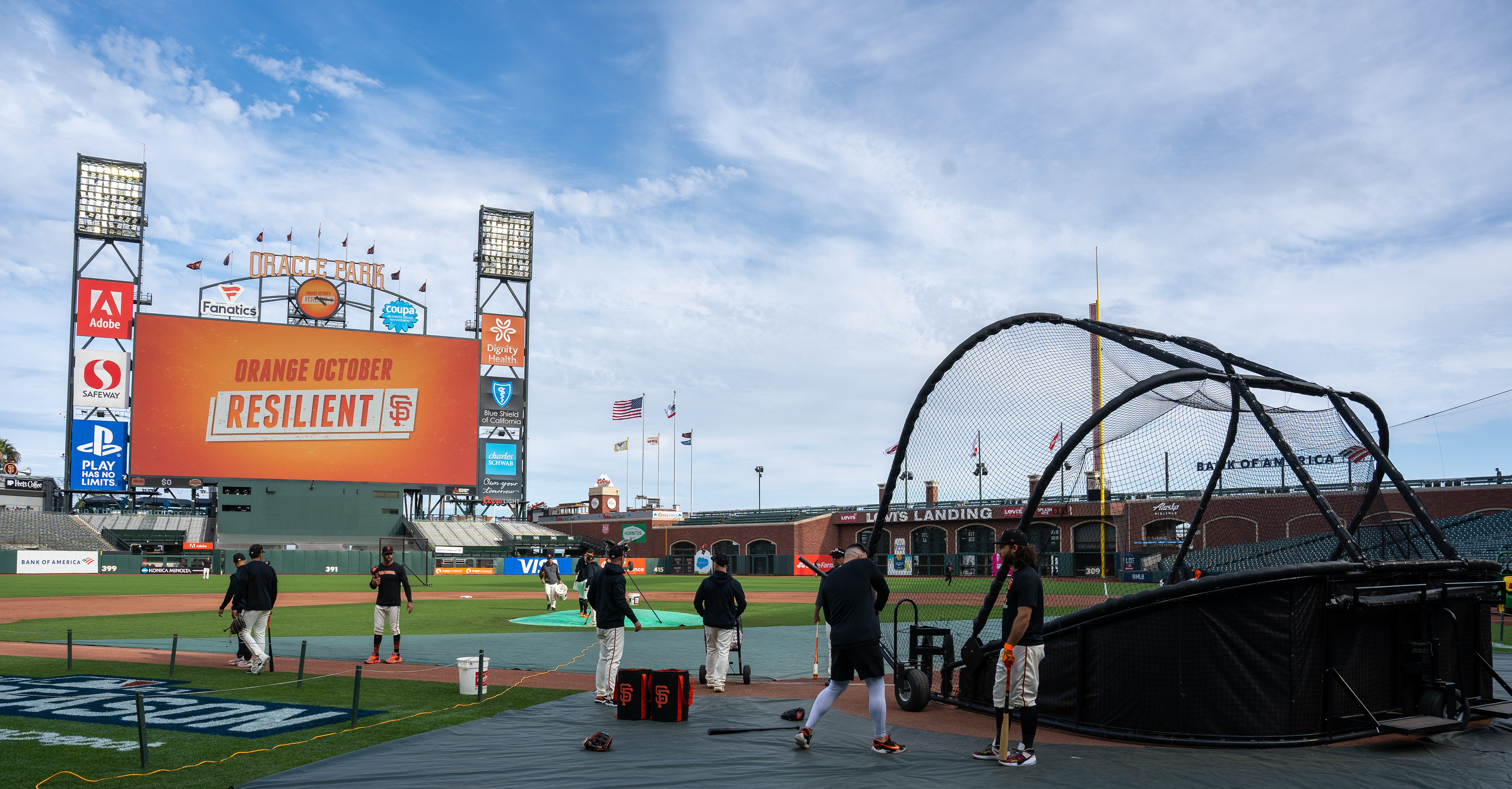 A hitting coach demonstrates a swing to Brandon Crawford, standing to the right. Crawford finished the season with a career-high batting average of .298 and twenty-four home runs.