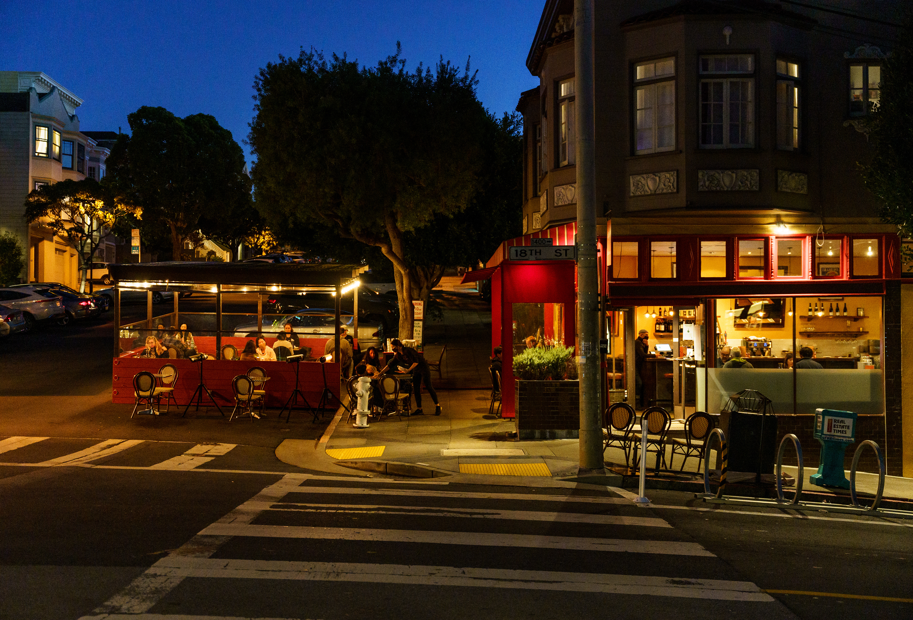 Outdoor dining lights up the night on 18th Street. Situated across from Christopher’s Books, Chez Mama creates a welcoming scene.