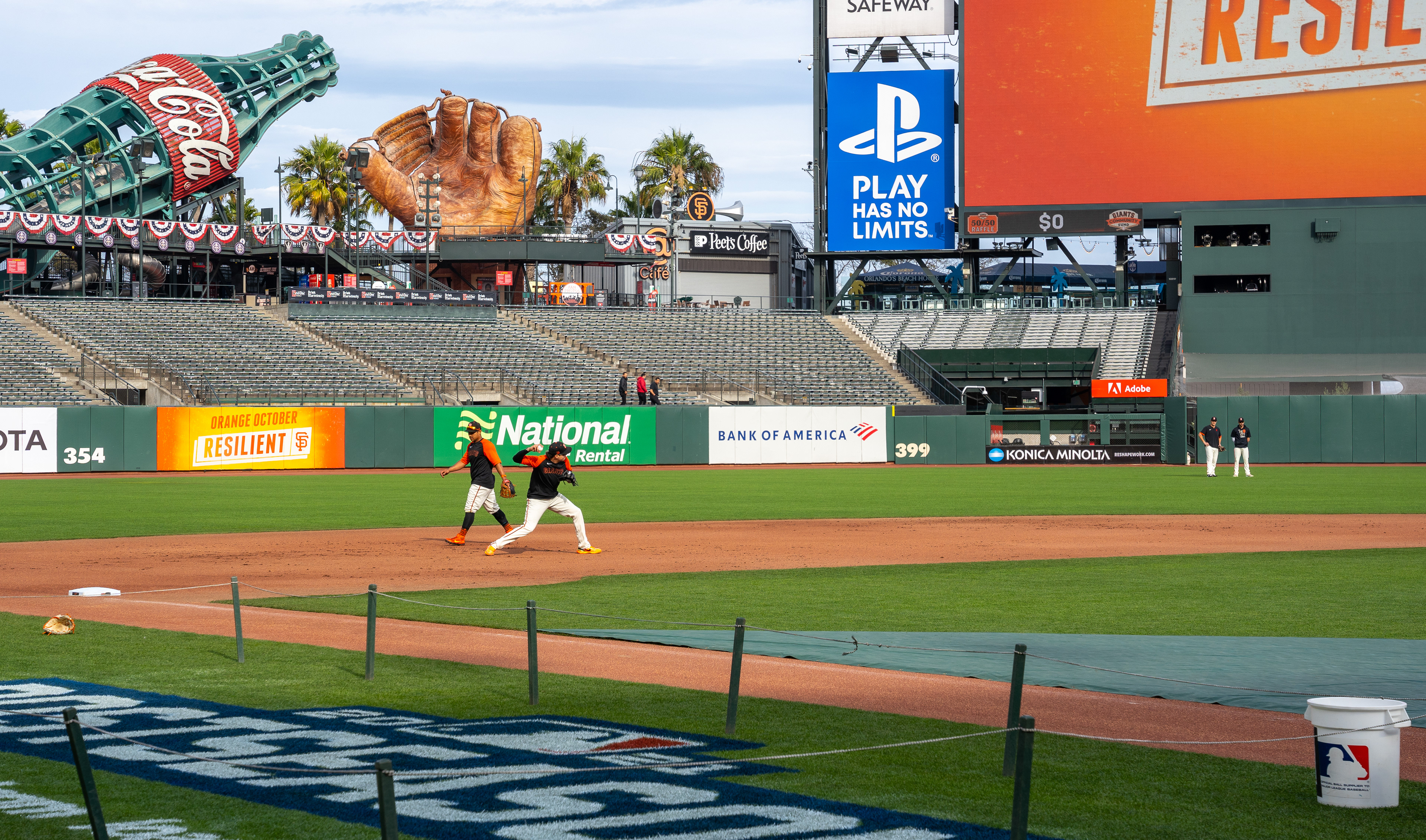 Third baseman Wilmer Flores fires a ball towards second base during practice.