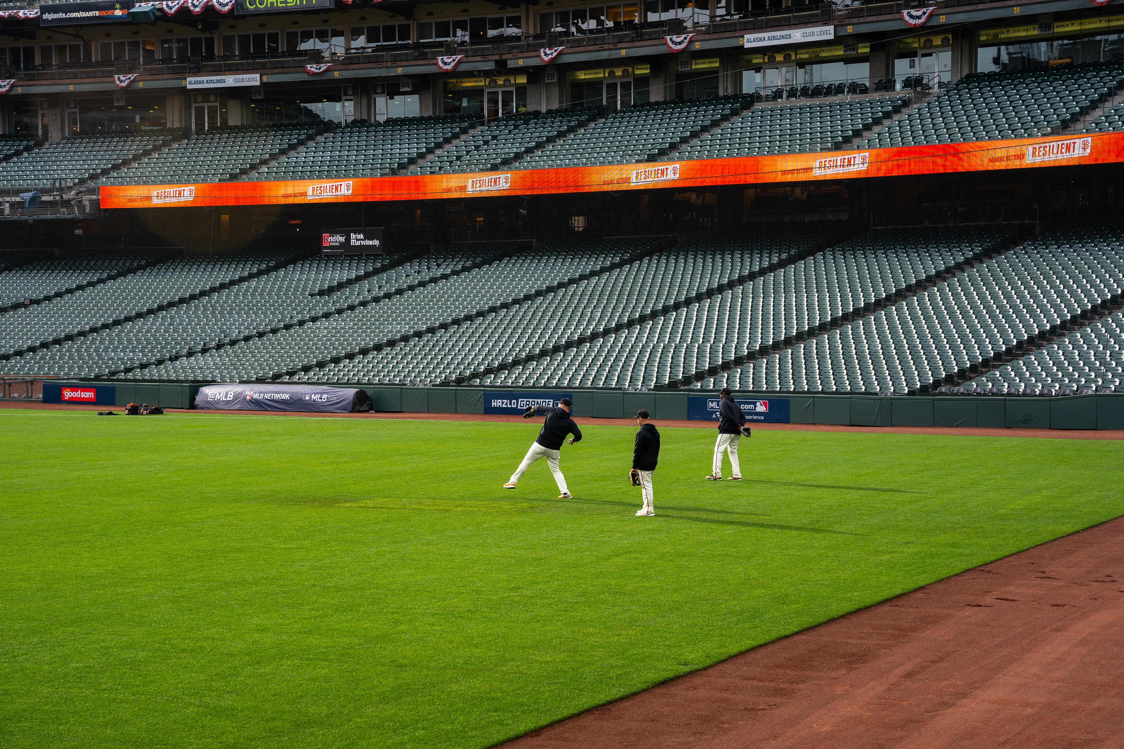 Giants shag balls in left field.