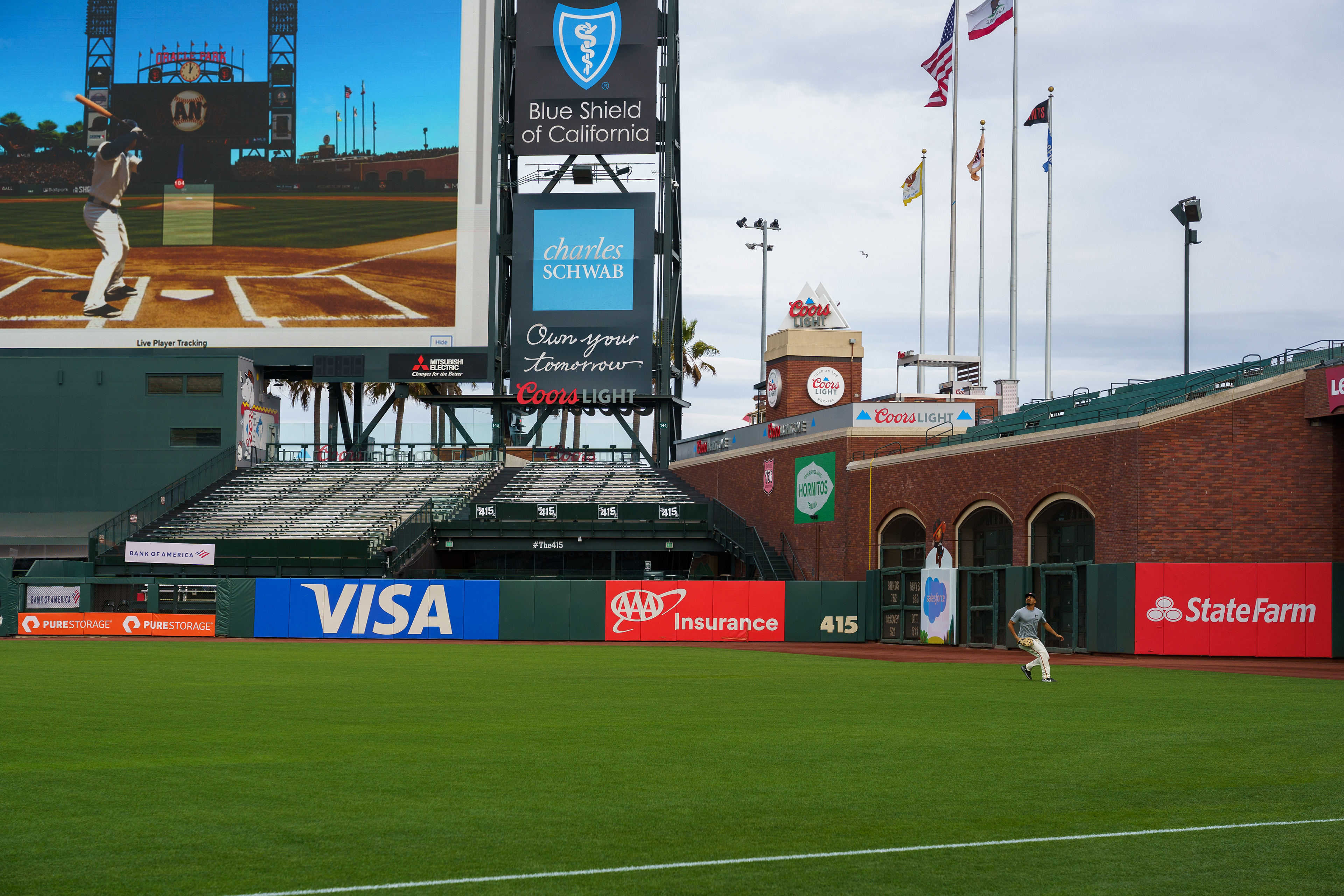 LaMonte Wade Jr. prepares to catch a fly ball to deep right field during practice..