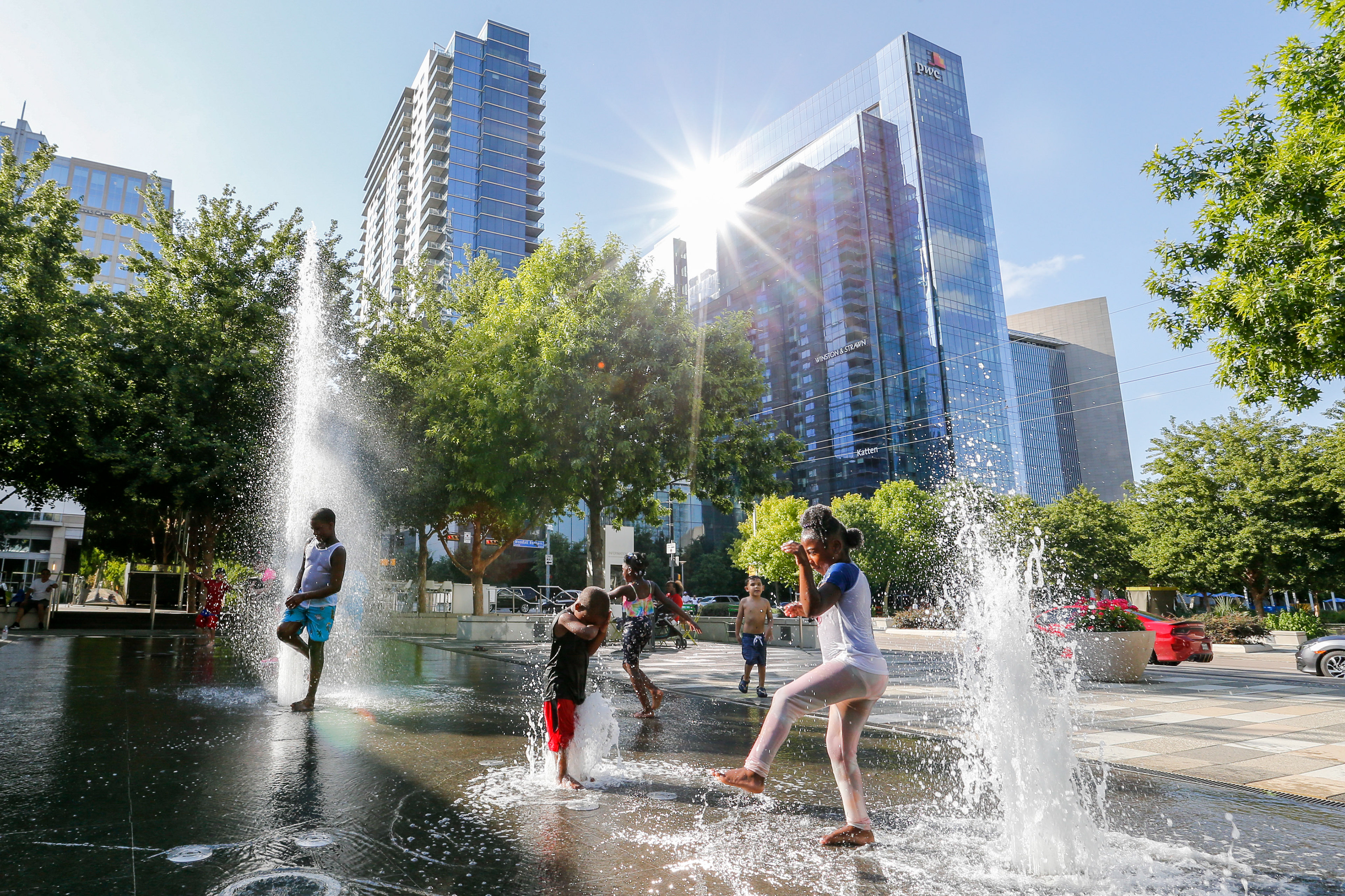 Children enjoy the Moody Plaza water feature at Klyde Warren Park on Wednesday, June 23, 2021, in Dallas.