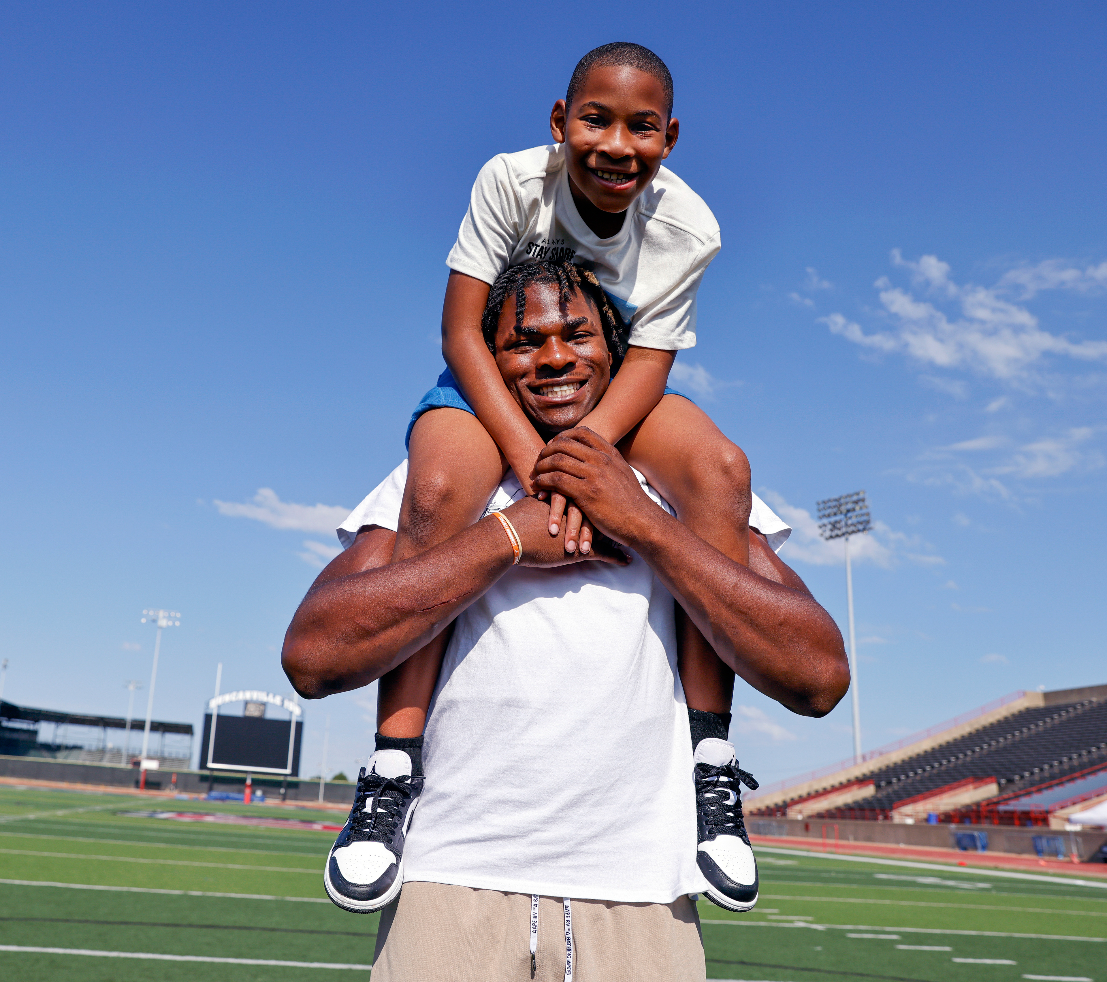 Duncanville defensive lineman Colin Simmons carries his brother Clayton Roberts, 8, at Duncanville High School, Tuesday, Aug. 15, 2023, in Duncanville, Texas.