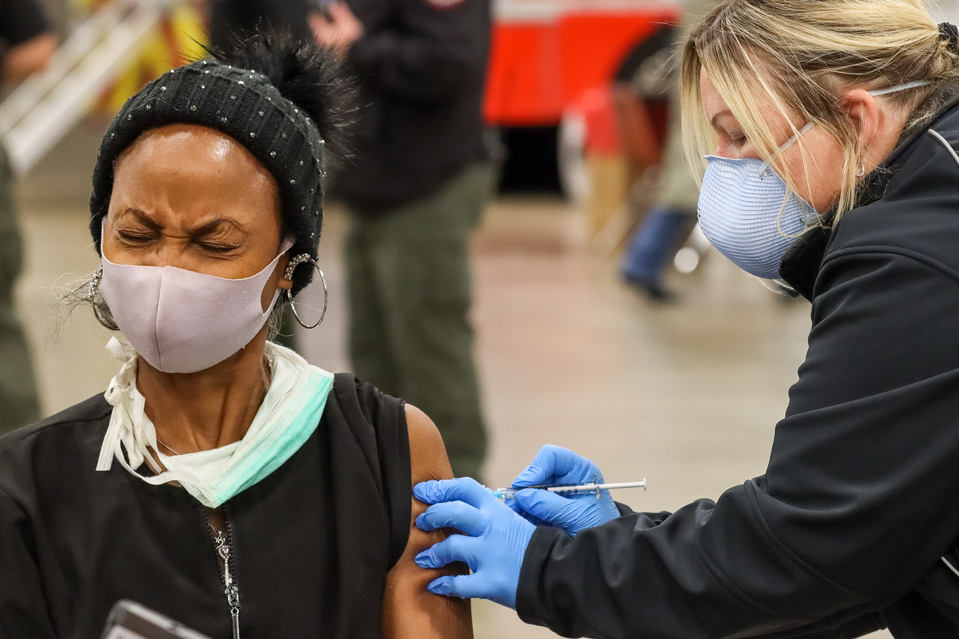 AMR Arlington paramedic Selena Schmidt administers the Moderna COVID-19 vaccine to Duncanville resident Tamara Lewis on Dec. 31, 2020 at Esports Stadium Arlington.