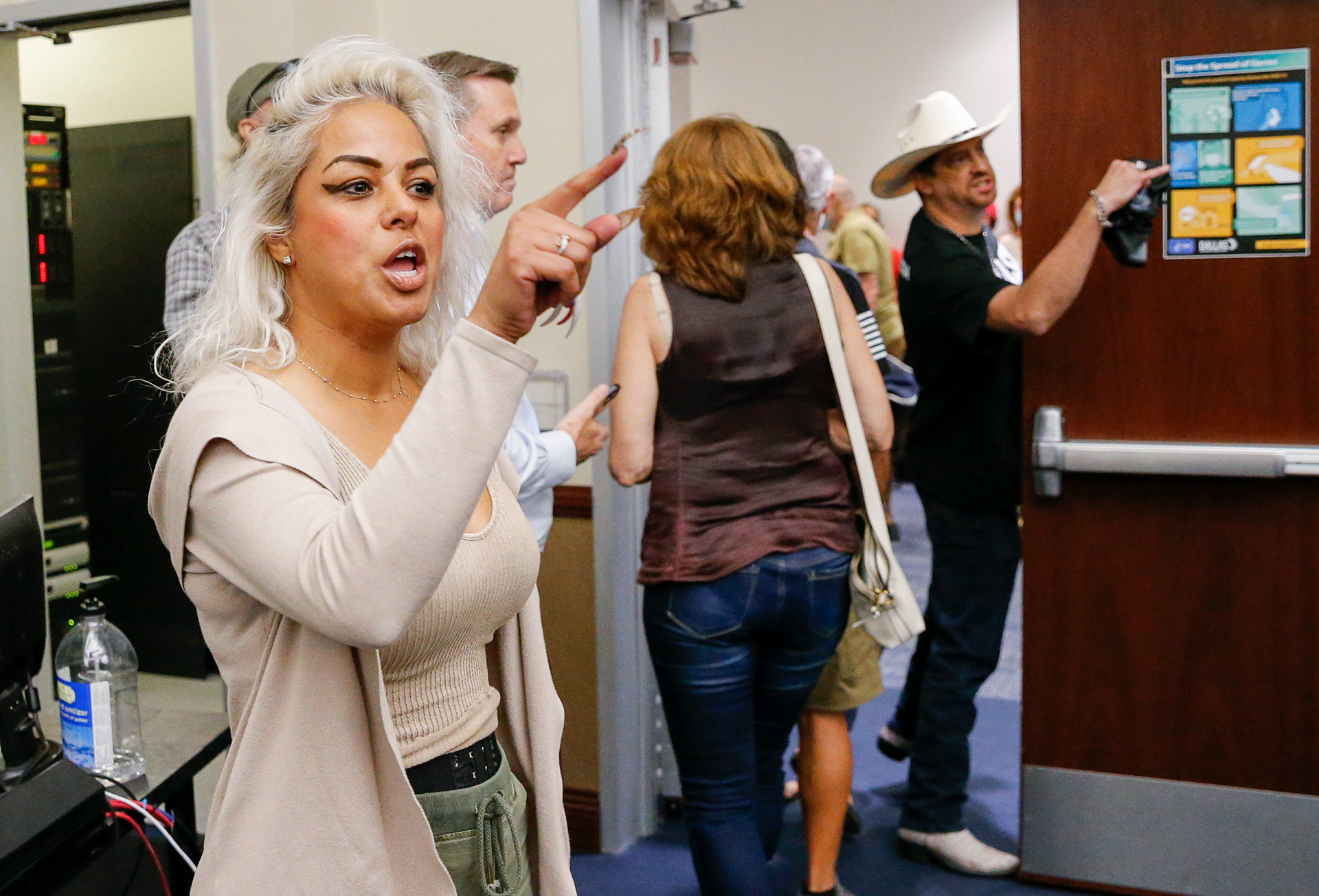 Opponents of mask mandates shout at school board members after moving into a closed session during a Dallas ISD school board meeting on Thursday, Aug. 26, 2021, in Dallas.