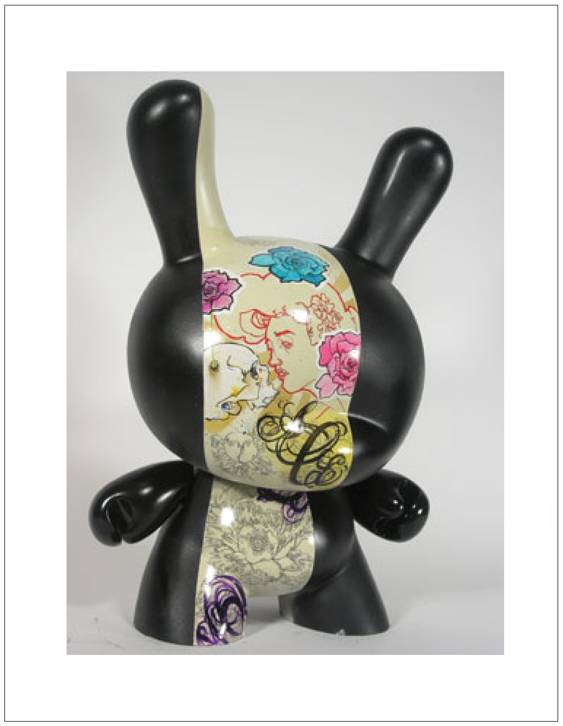 custom hand painted rabbit shaped toy with a women, flowers and lettering.