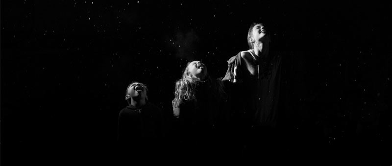 Documentary family photo of three kids in the first snow. Taken by Callie Cooper.