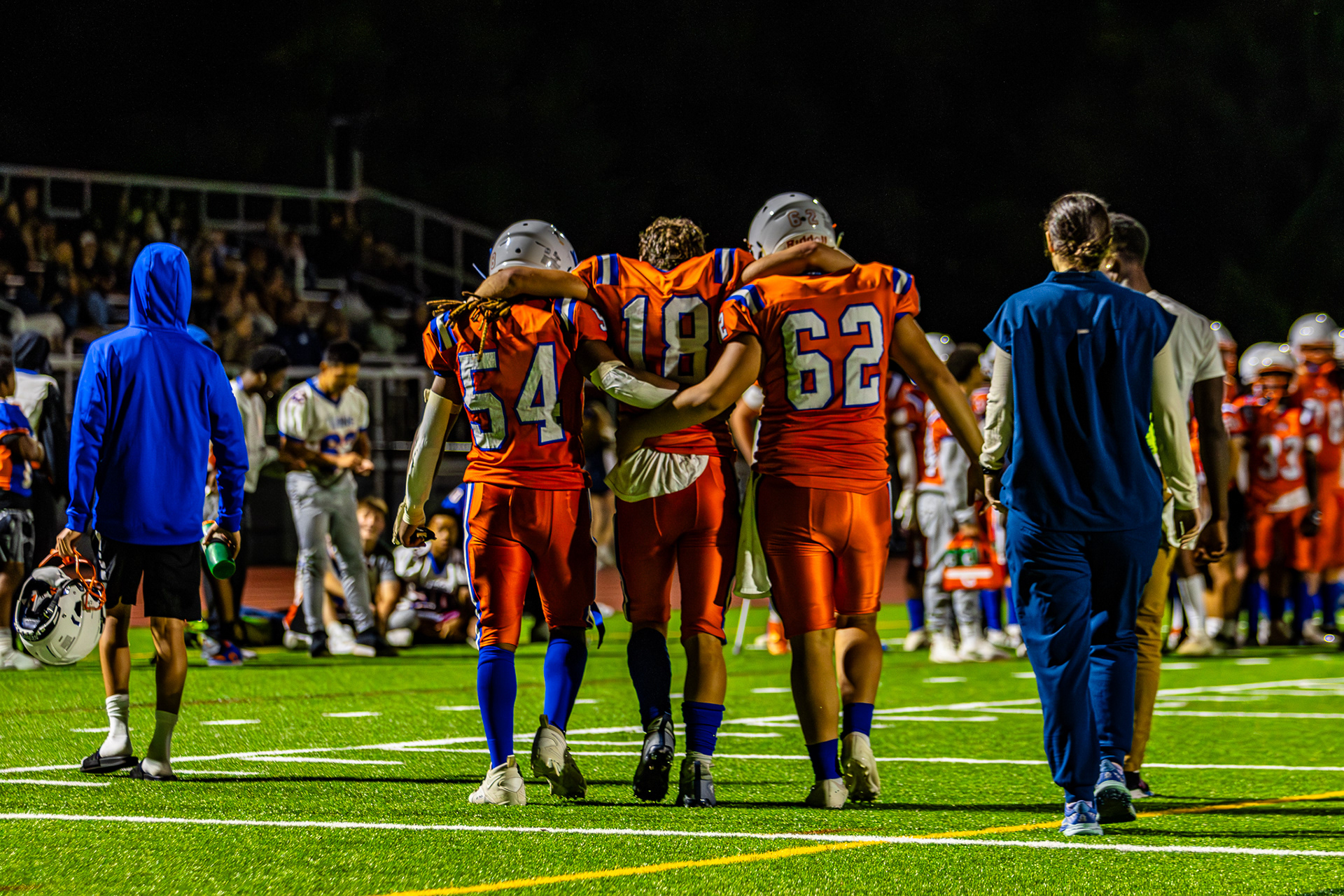 Newton South Player Beckett Shrier being helped off the field by teammates after injury. Shot on Canon R7, Canon EF 70-200 f2.8.  9/13/2024