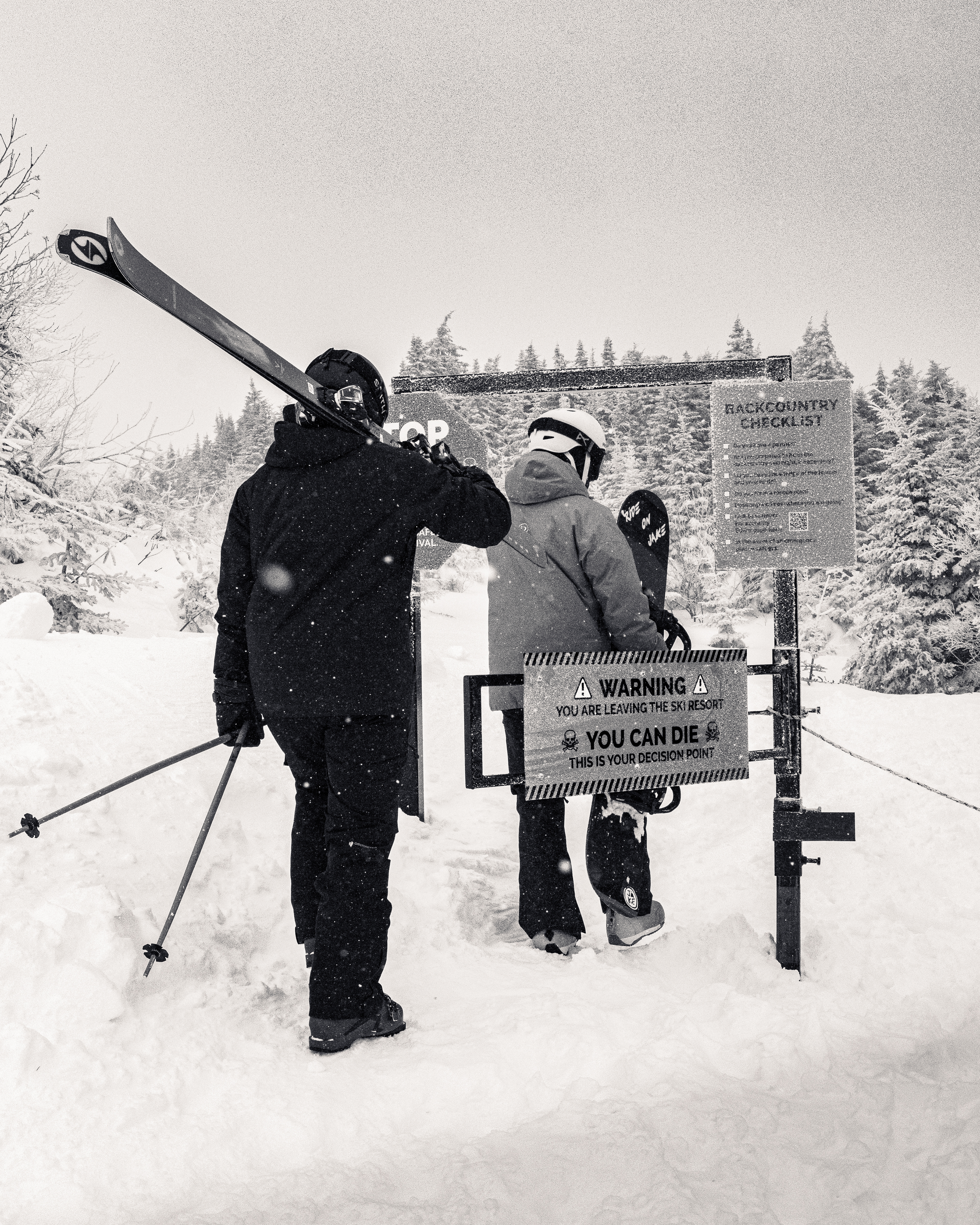 Skier and Snowboarder hike backcountry despite warning signs. Shot on Sony a6700, Sigma 24-70 f2.8. 2/20/25  