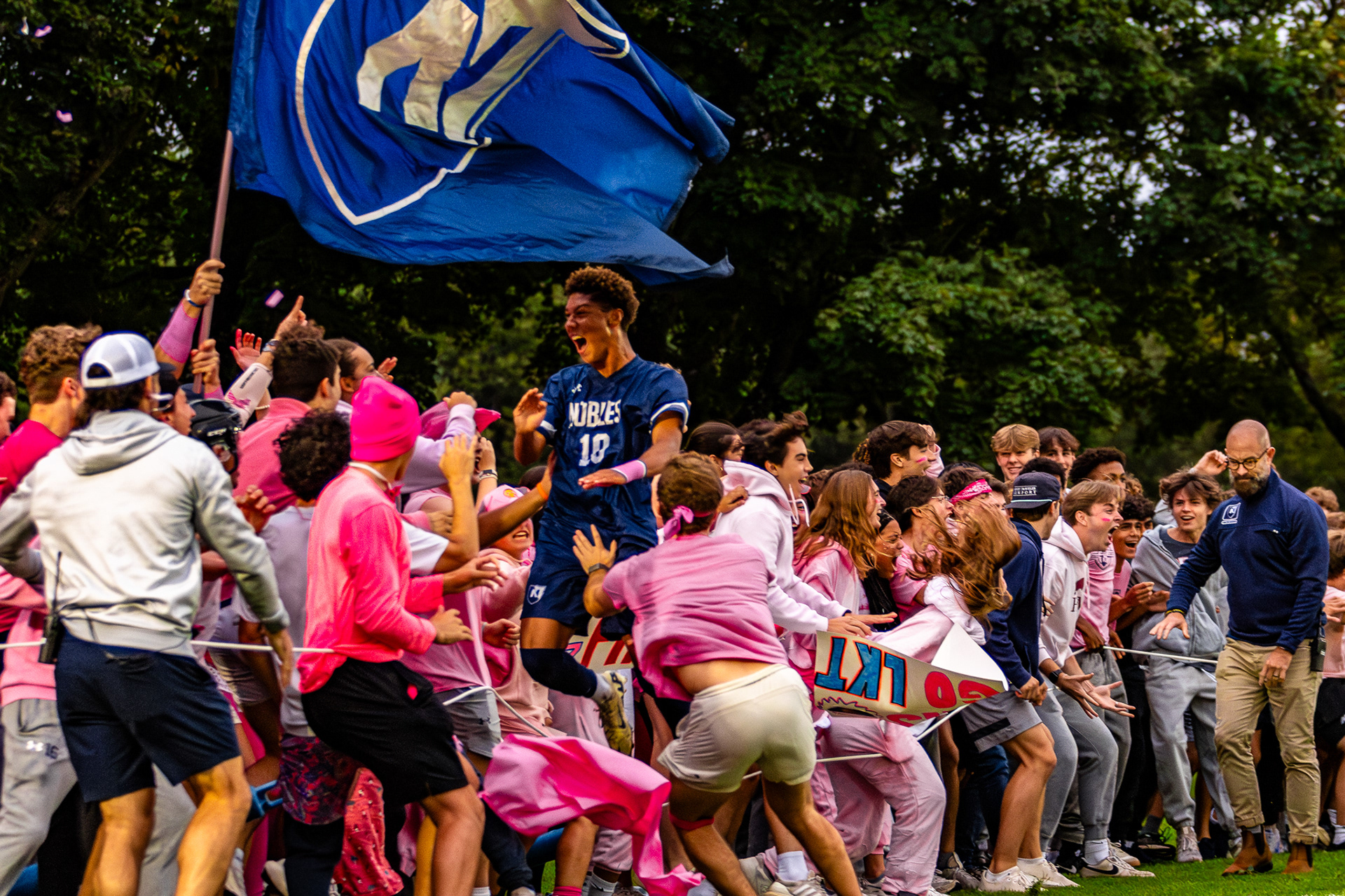 Junior player Juju Fynn-Thompson leaps into the crowd after scoring the game winning goal in a rival match. Shot on Canon R7, Canon EF 70-200 f2.8.  9/21/2025