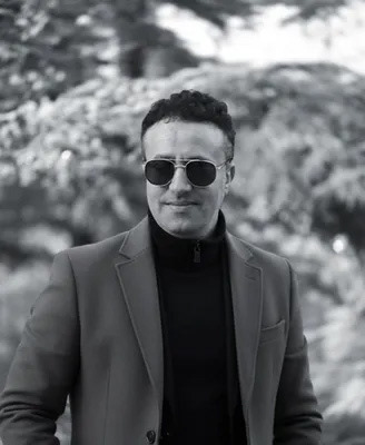 Artist photo wearing black sunglasses