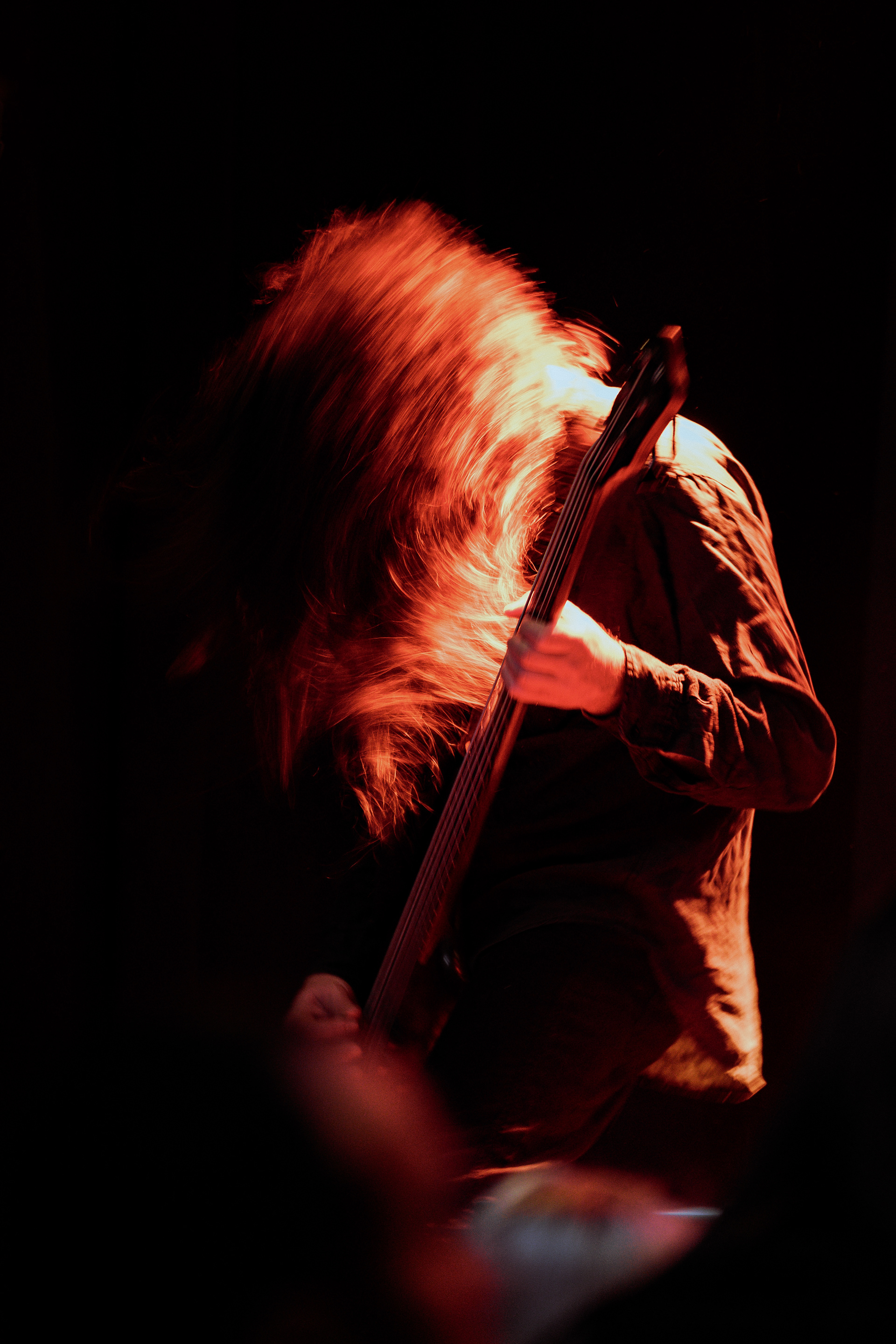 Headbanging bassist from Sur Austru caught in motion, delivering powerful performance at Rockstadt Club in Brasov.