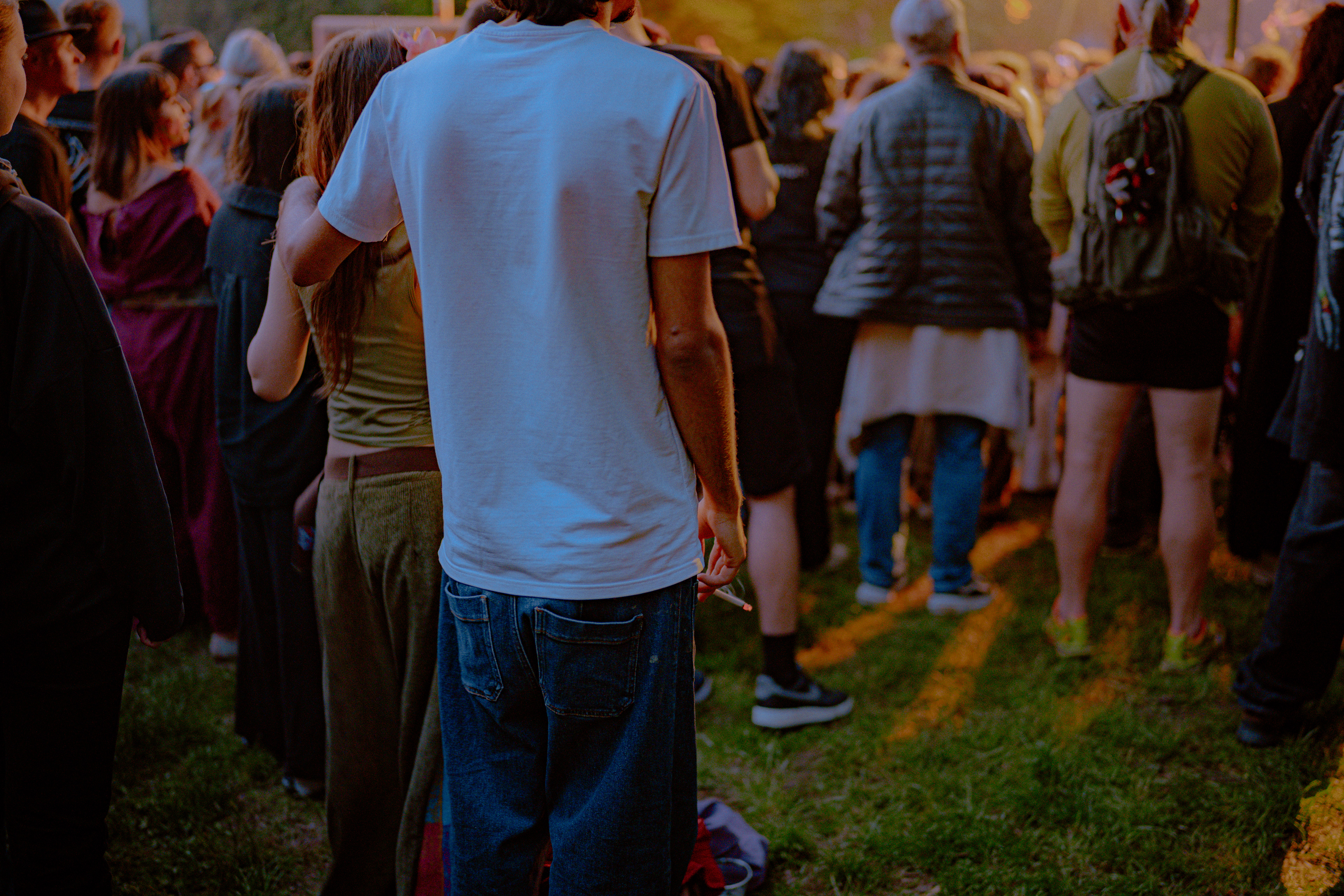 Live event photography showing teenagers hugging and smoking cigarettes in the crowd during Om La Luna’s concert.