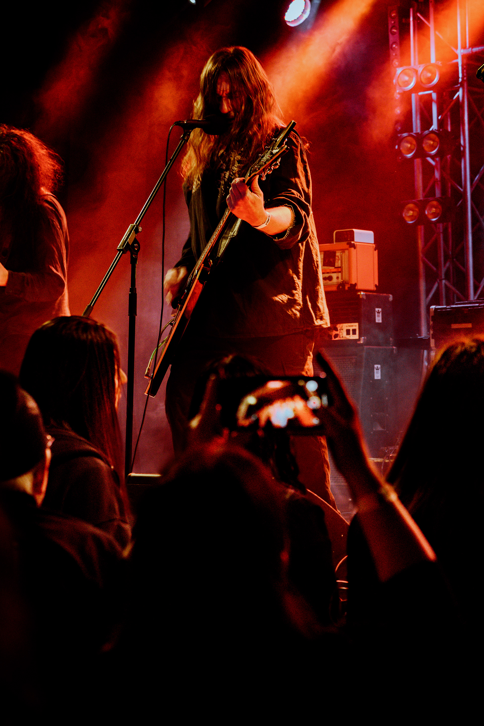Sur Austru vocalist singing, playing guitar, and screaming into mic during intense live set at Rockstadt Club in Brasov.
