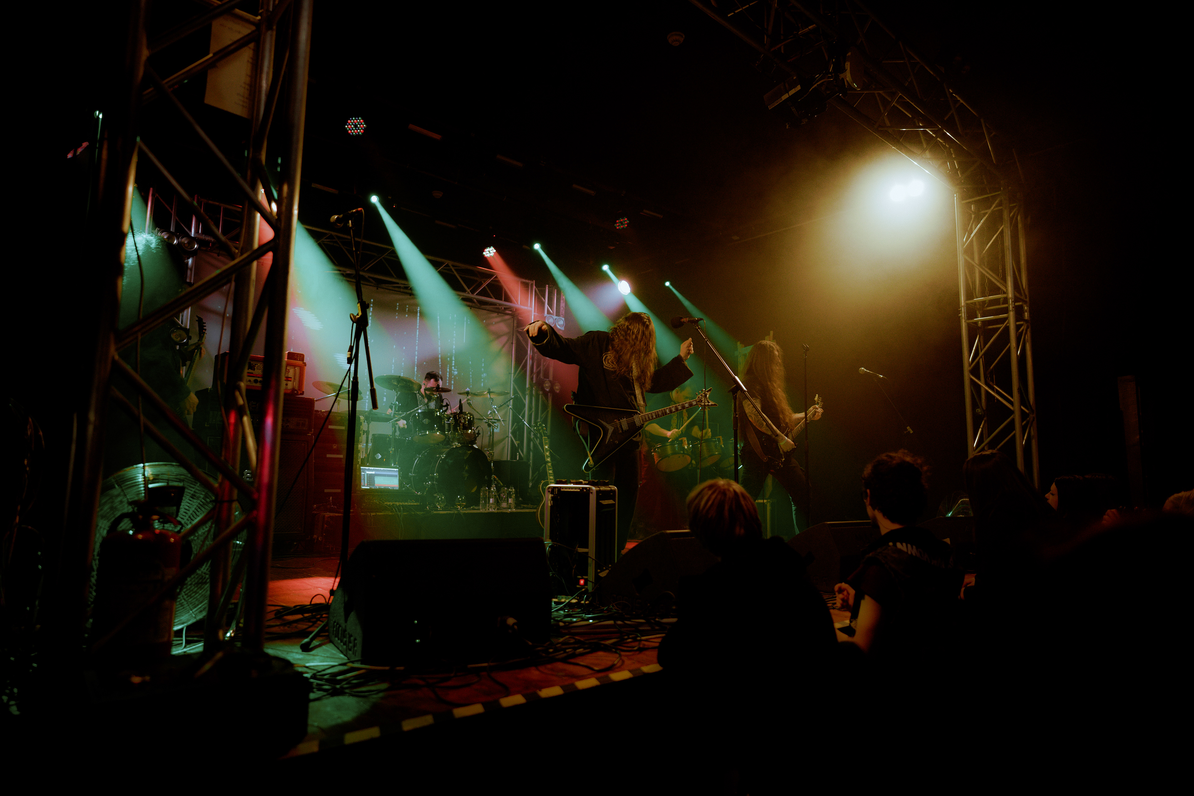 The crowd watching Sur Austru band members posing in a ritualic formation during live show at Rockstadt Club, Brasov.