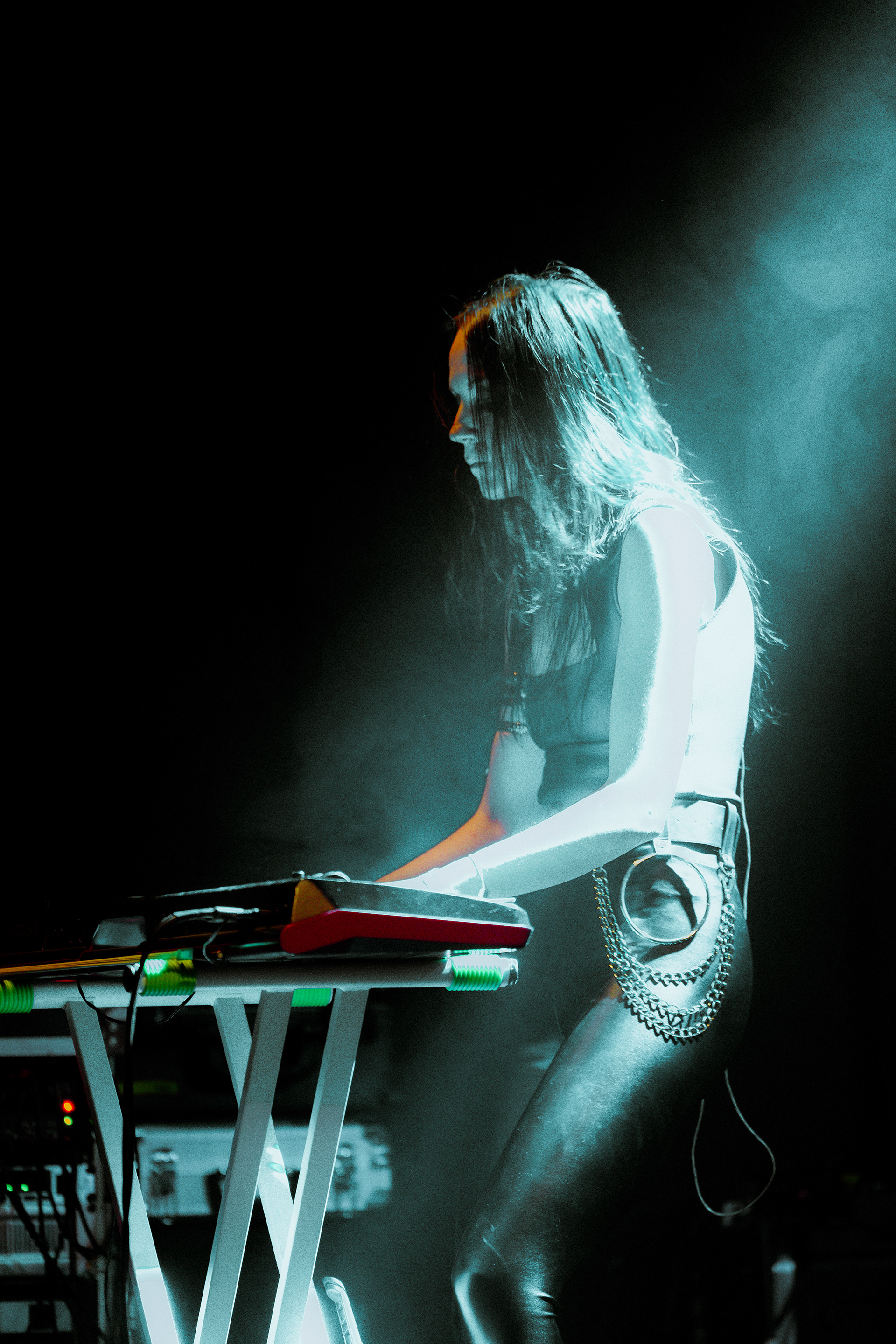 Pianist of Eternal Fire performing under atmospheric stage lighting, adding depth to their live show.