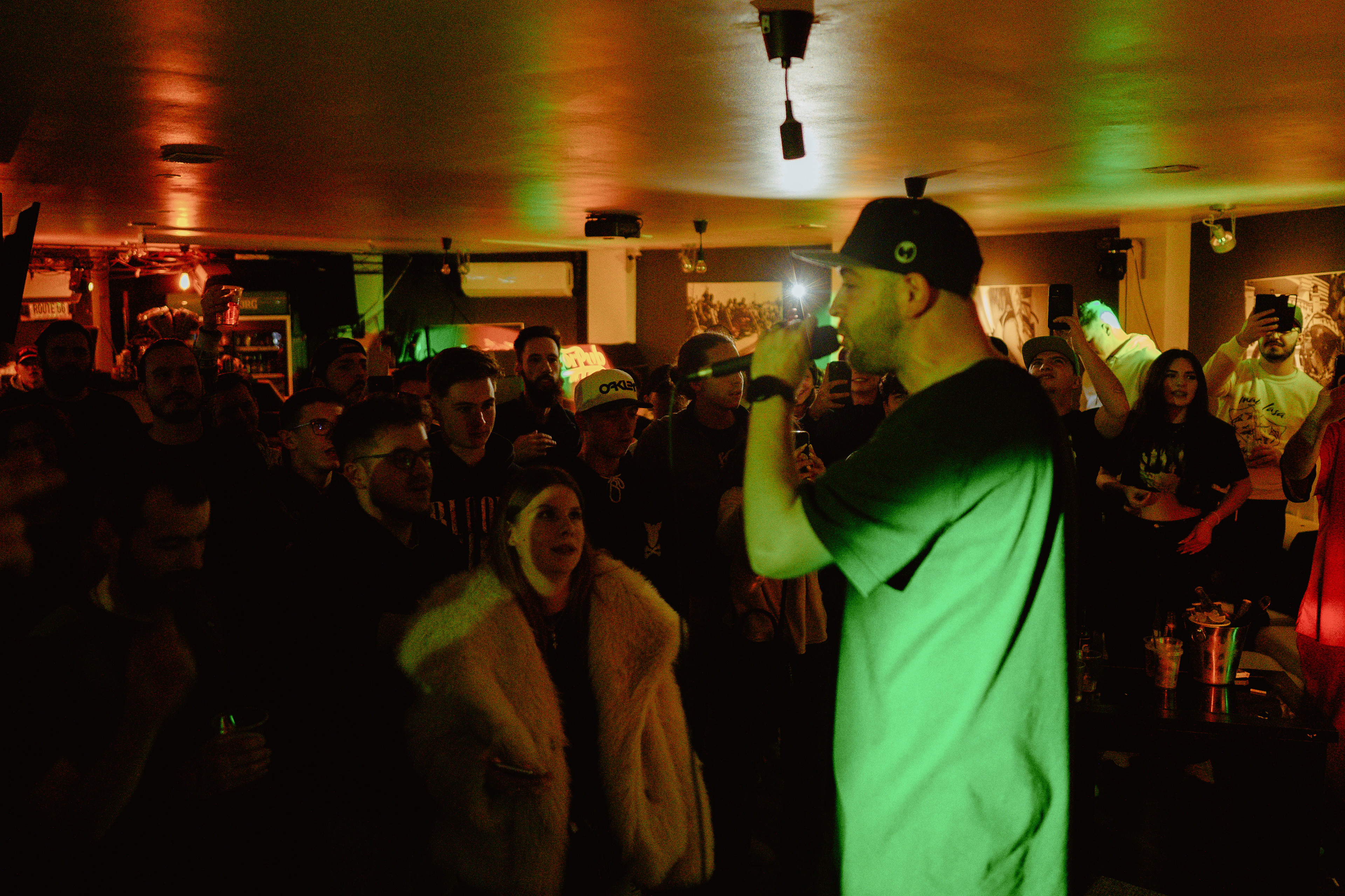 Concert photography of Faust singing intensely in front of the crowd at Motorpub club in Brașov, Romania.