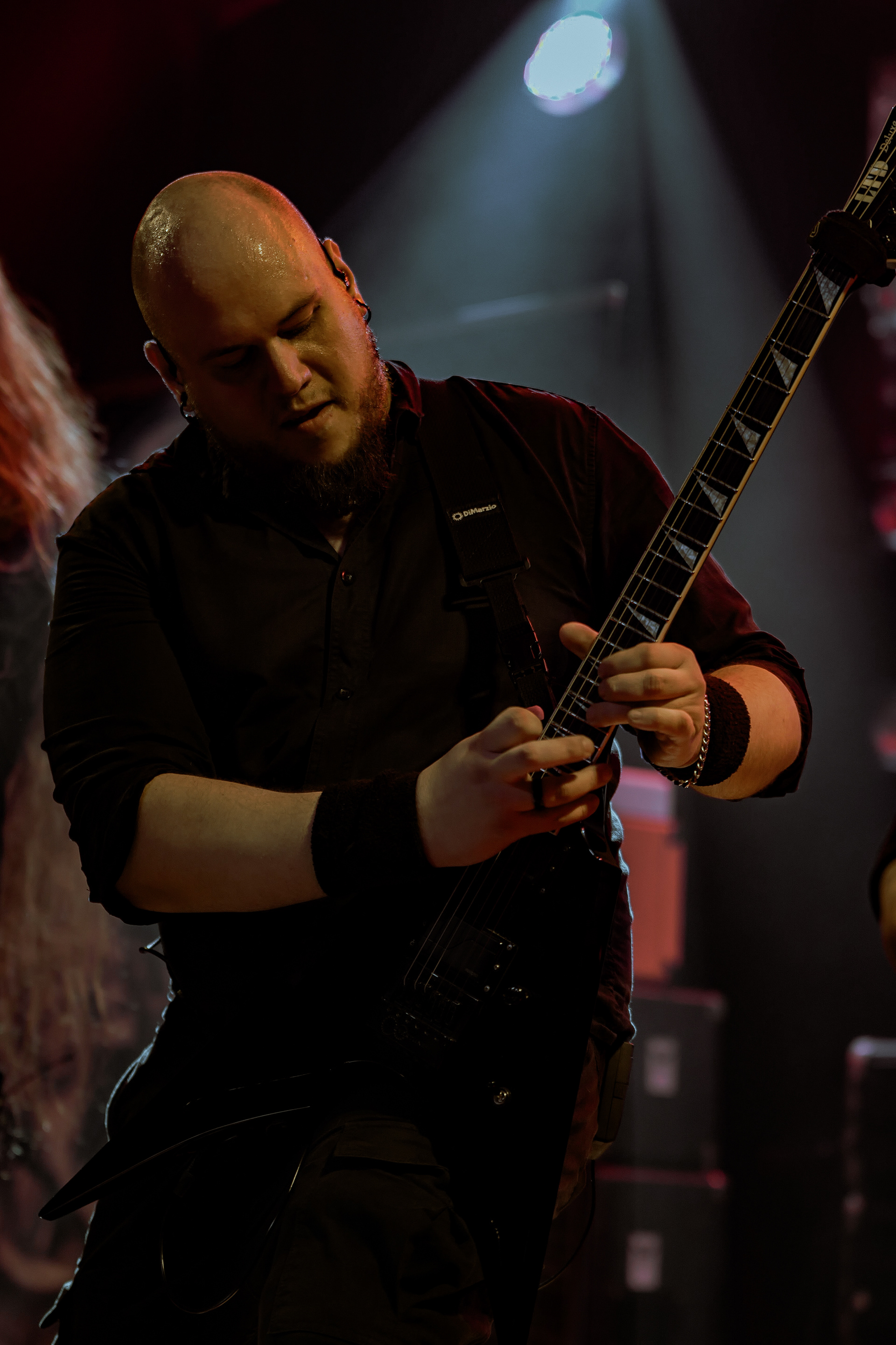 Dynamic concert photography of Machiavellian God’s guitarist shredding a powerful riff during a live performance at Rockstadt Club, Brașov.