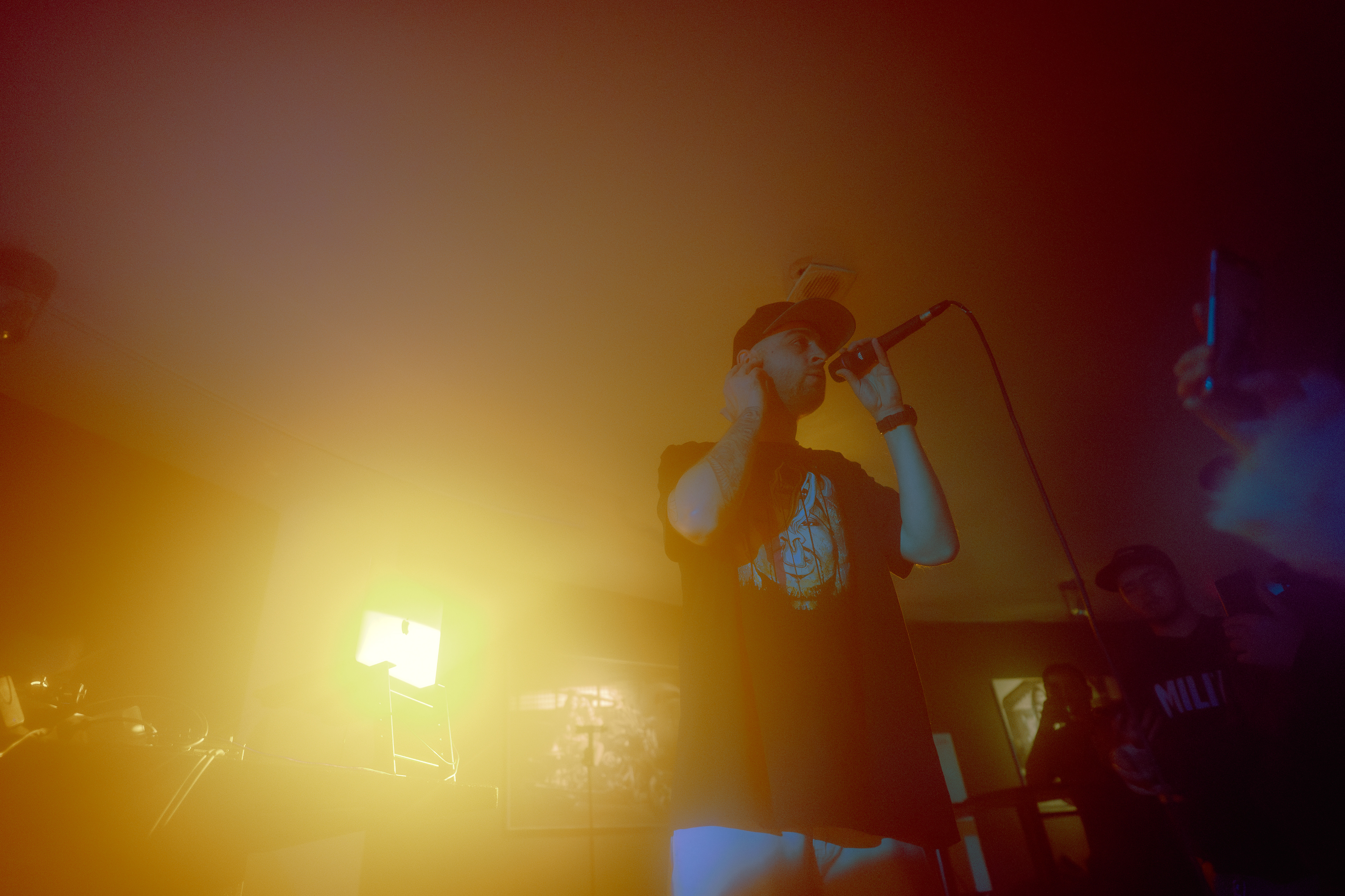 Concert photography capturing Faust delivering lyrics passionately under warm stage lighting at Motorpub in Brașov, Romania.