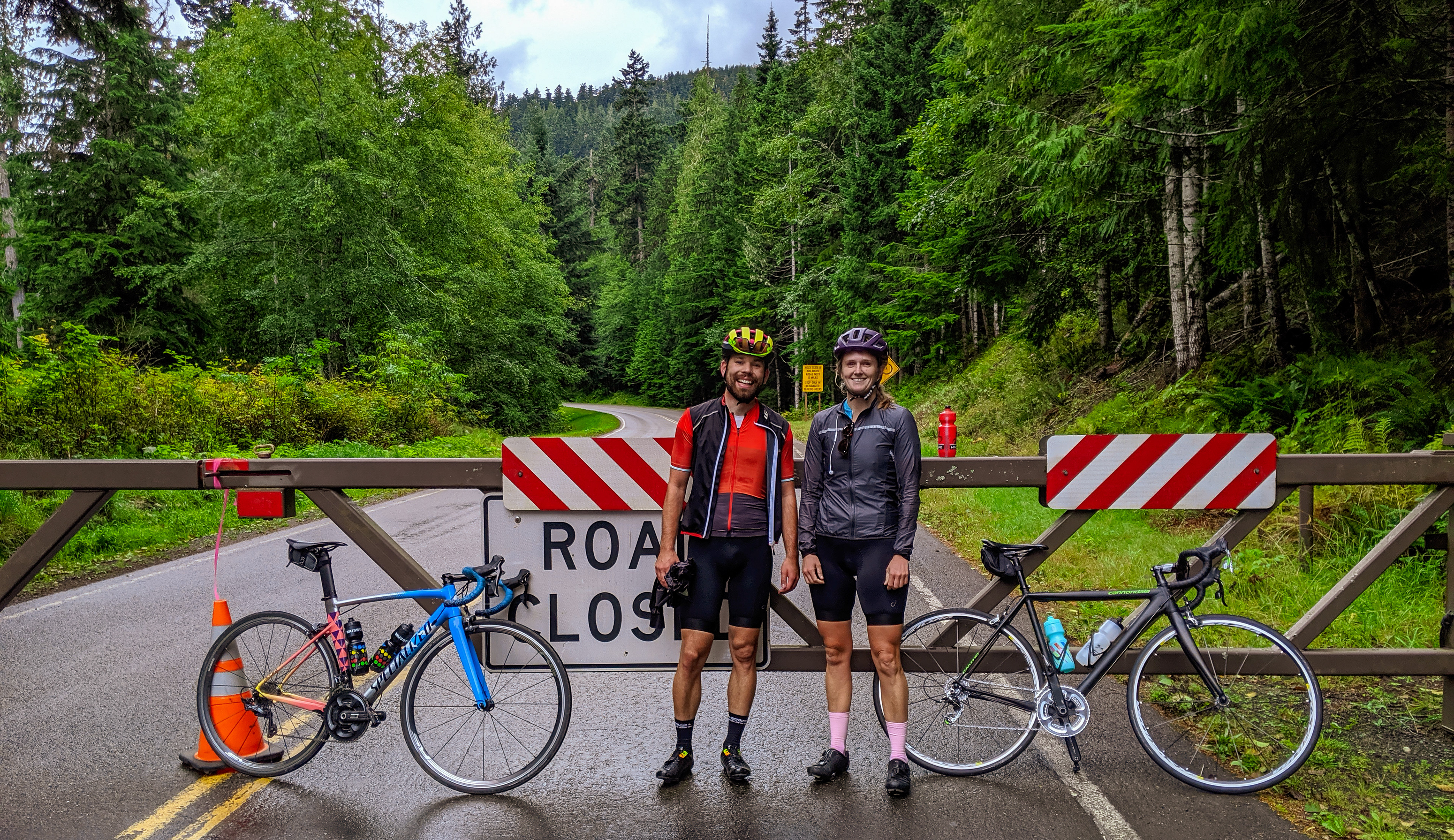 Two friends on a mountain road with their road bicyles.