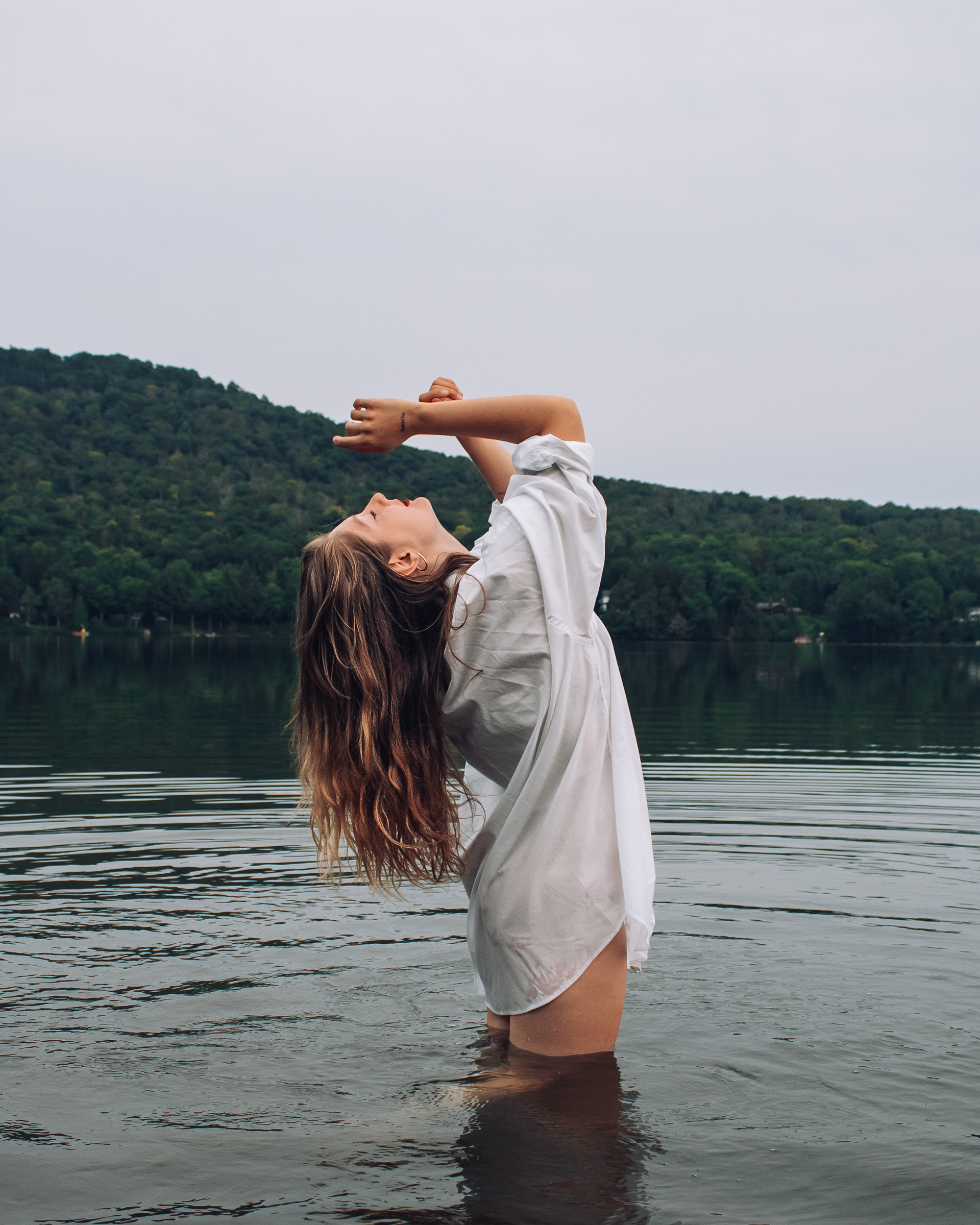 Portrait of a woman in a lake for a creative photoshoot