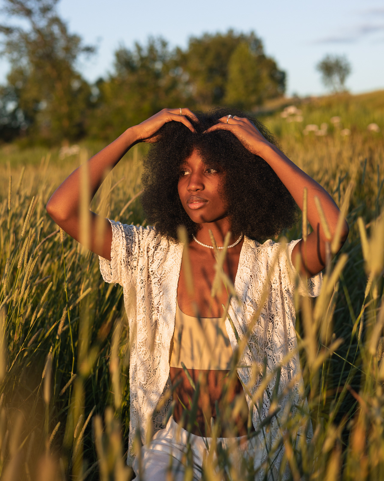 Portrait of a woman in a field at golden hour