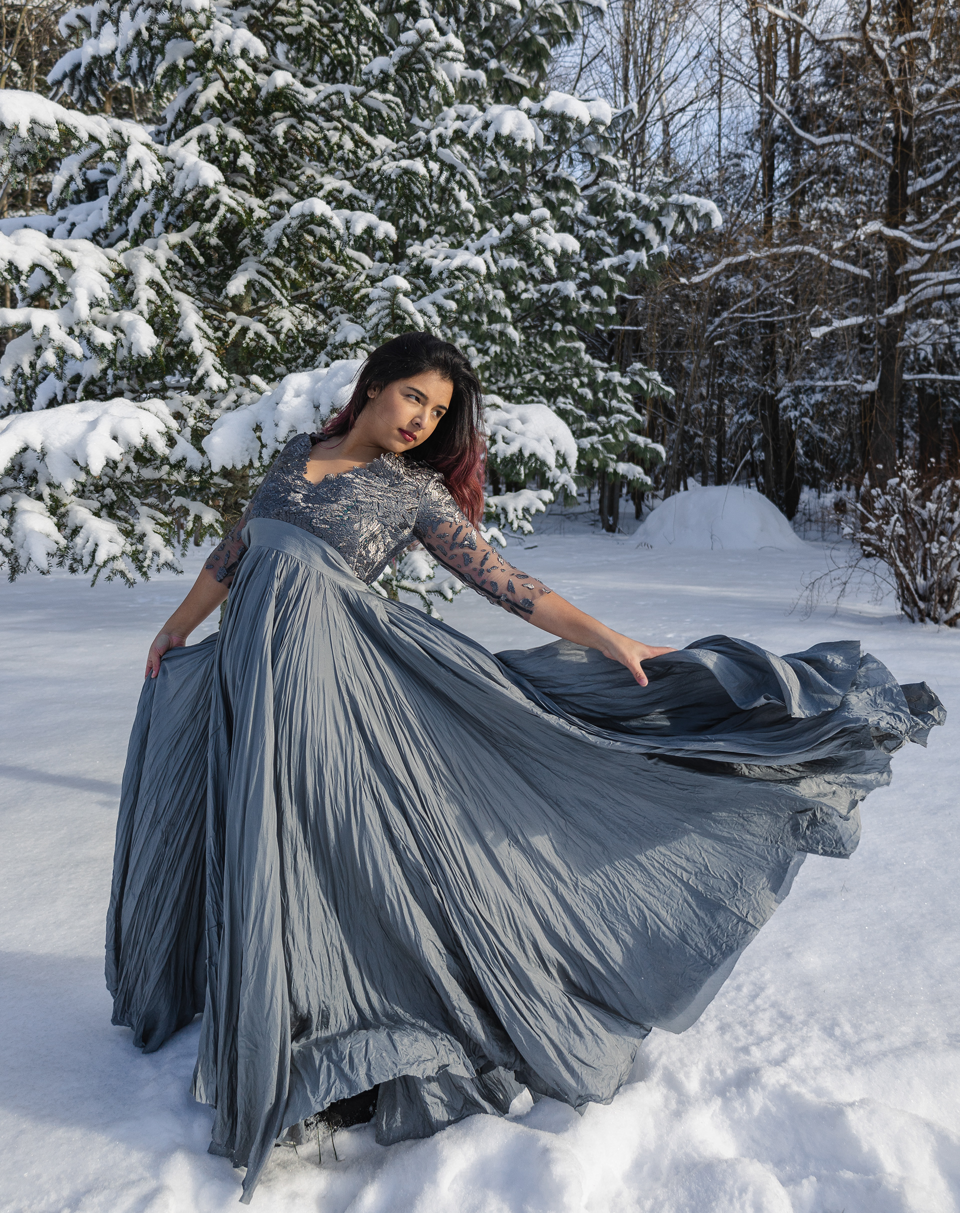 Portrait of a woman wearing a silver dress in the snow