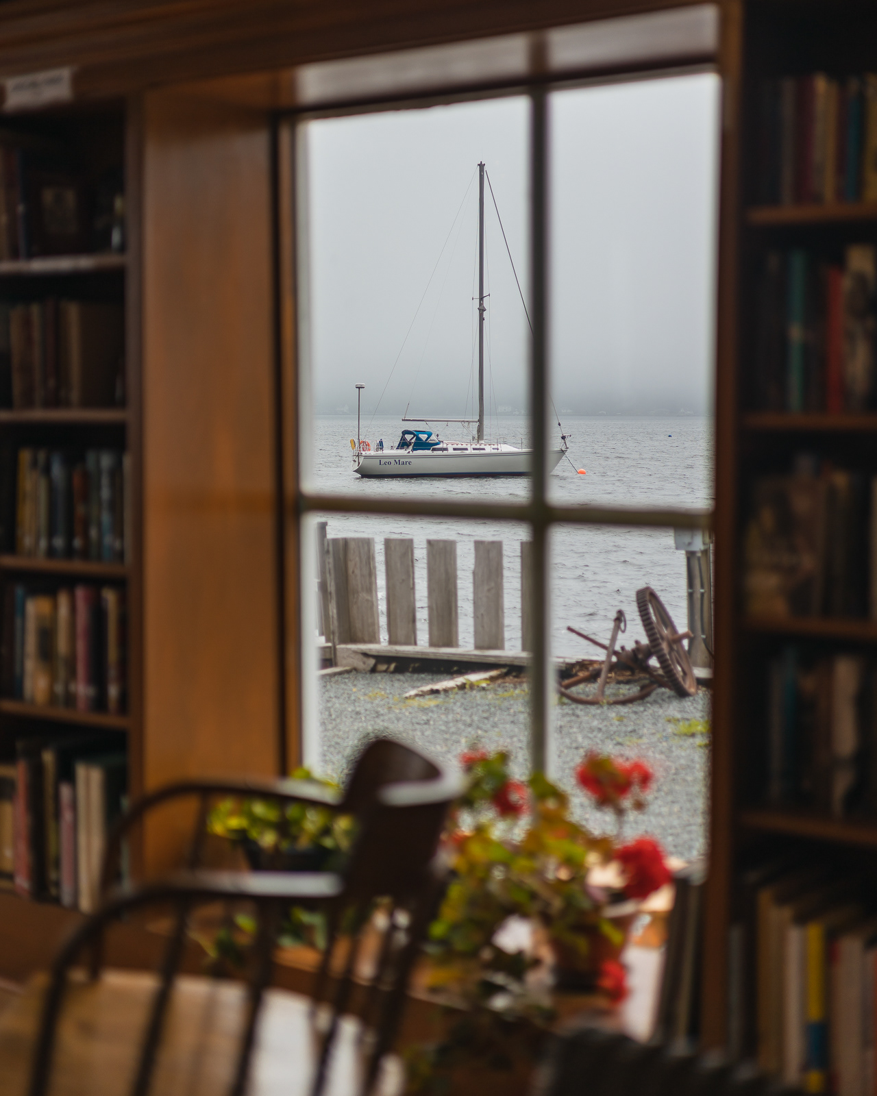 View of a sailboat through a bookstore window in Nova Scotia, Canada