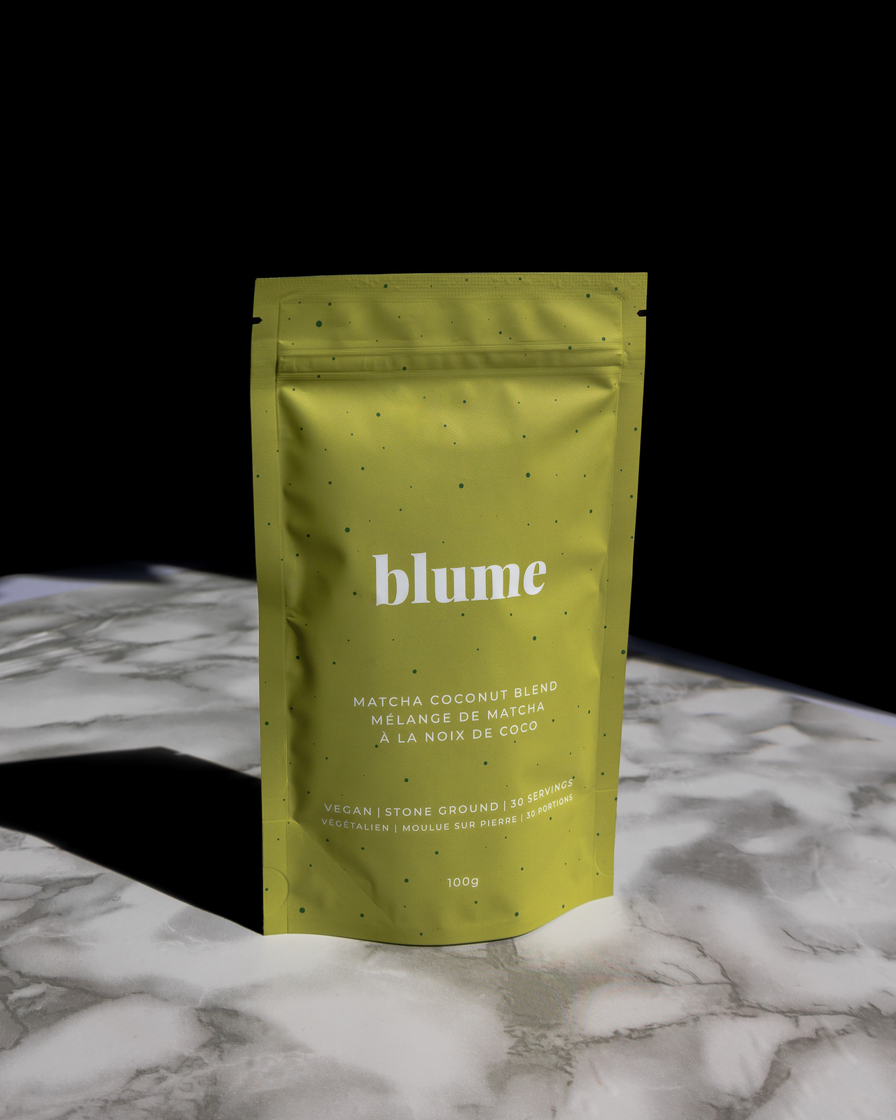 Matcha tea bag on a marble table and a black background