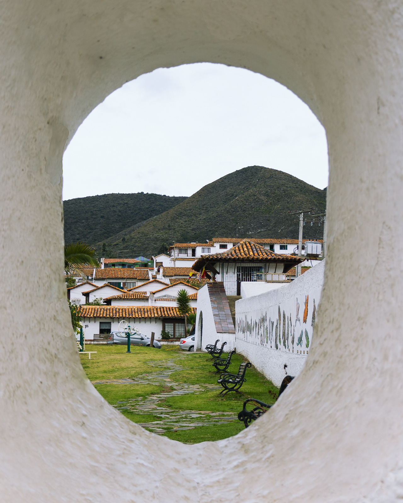 View of Guatavita town through a hole in a wall in Colombia