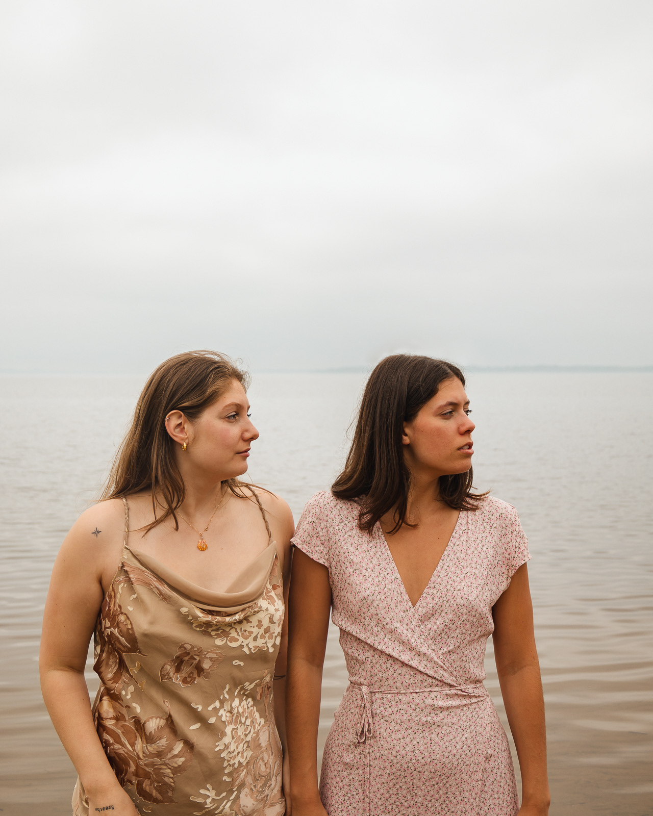 two women pose in front of a lac in Montreal