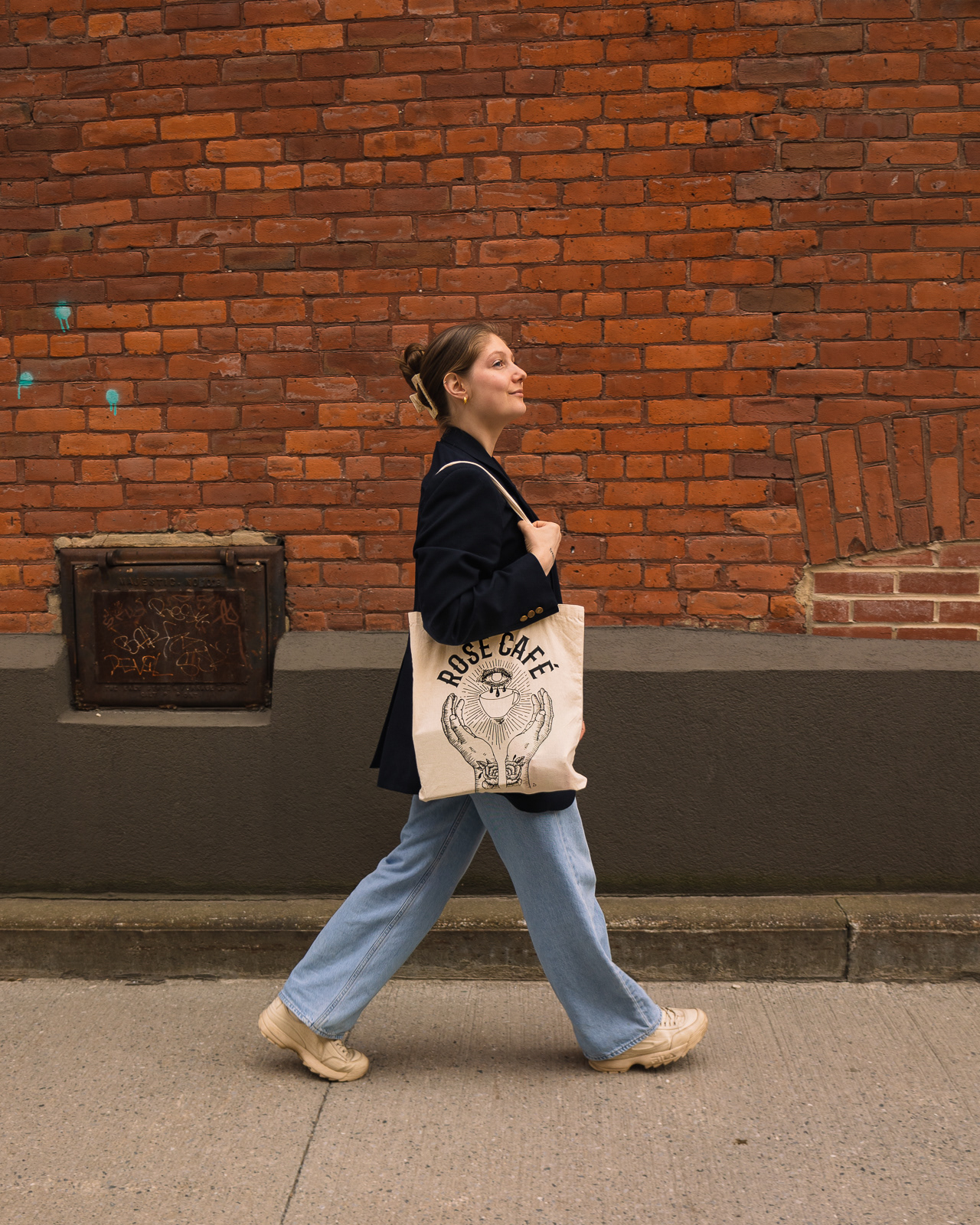 Woman walking with her tote bag for a product photoshoot