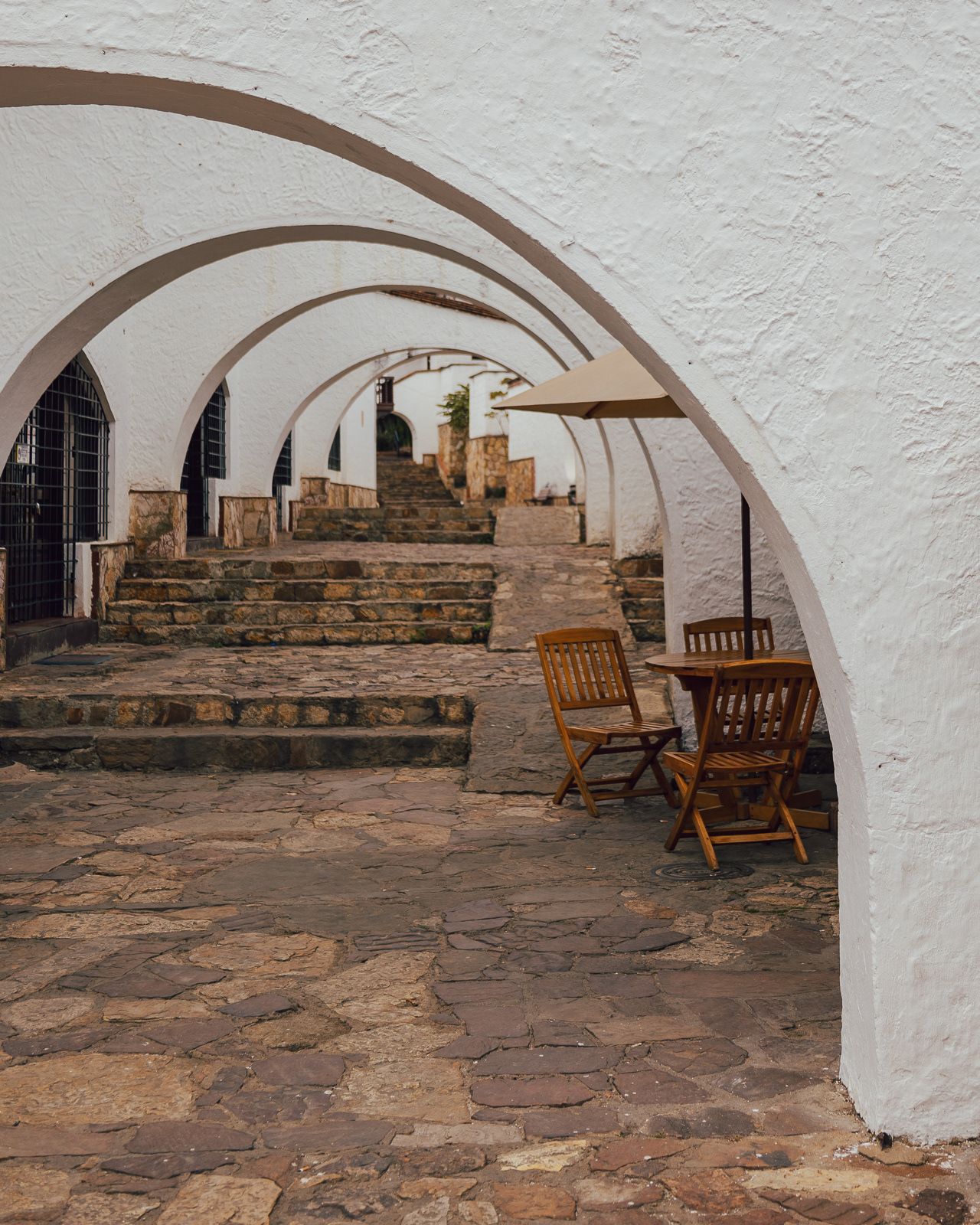White arches and cobble street in Guatavita, Colombia